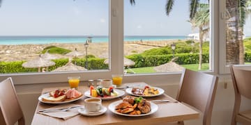 a table with plates of food and drinks on it