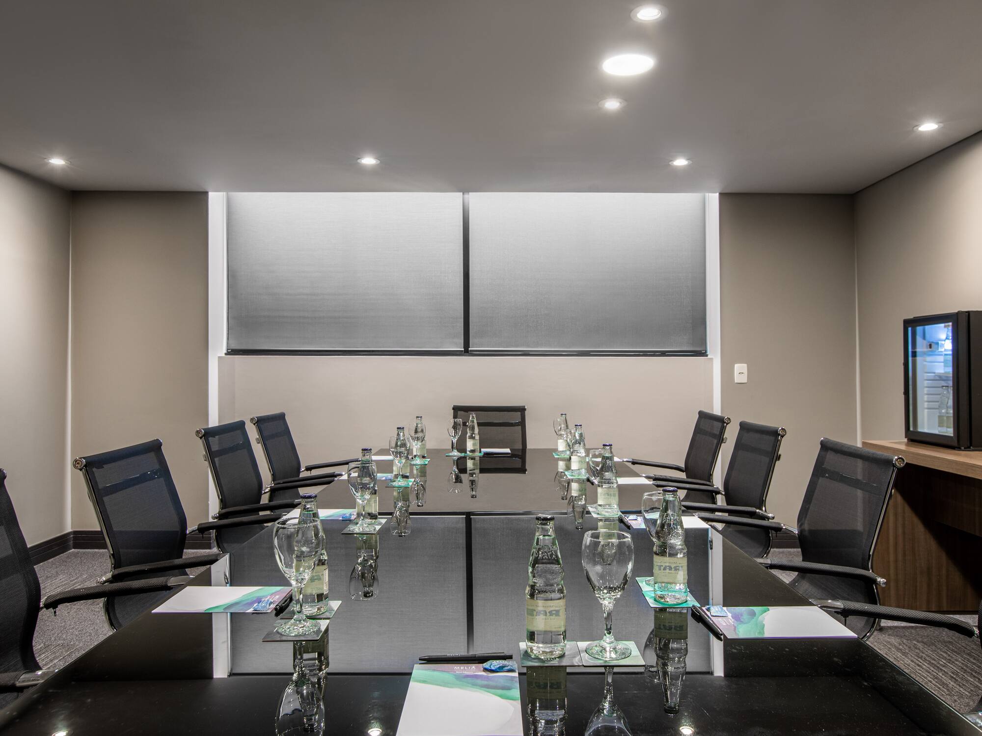 a conference room with a table and chairs