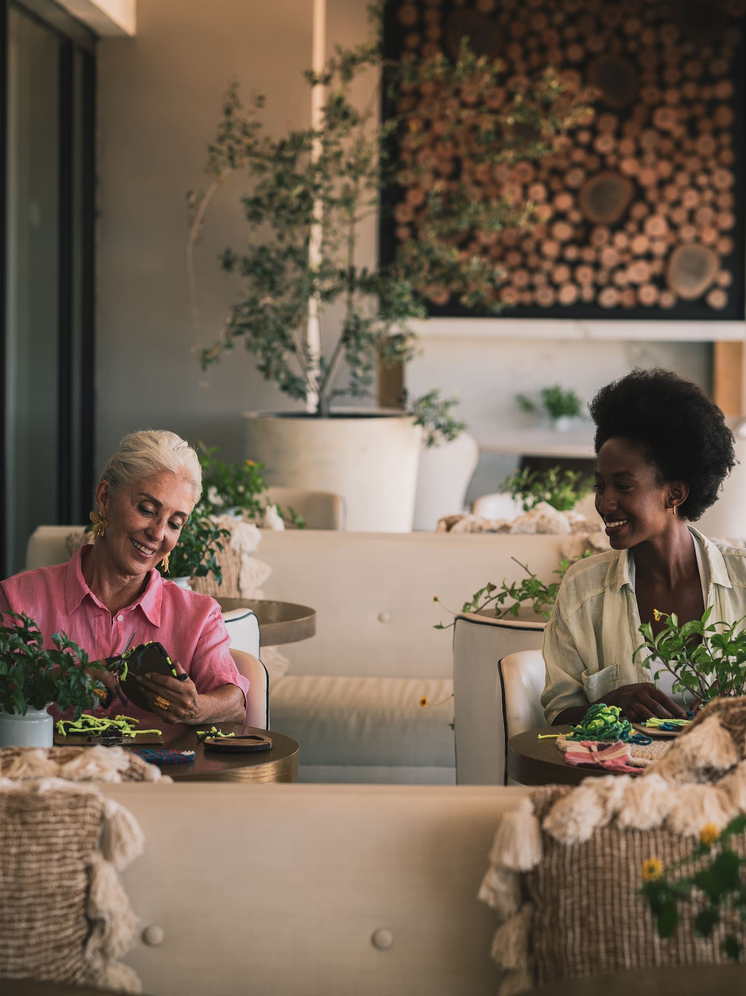 two women sitting at tables in a restaurant