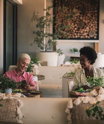 two women sitting at tables in a restaurant