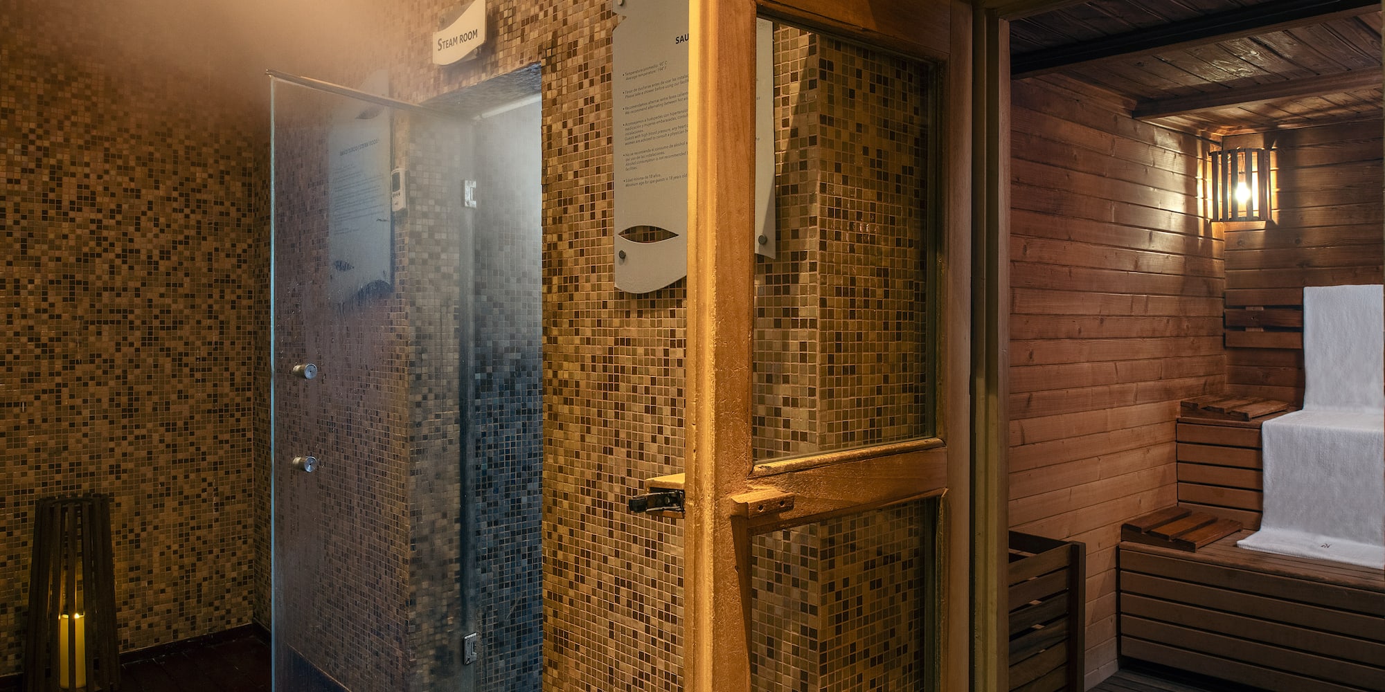 a room with a glass door and a sauna