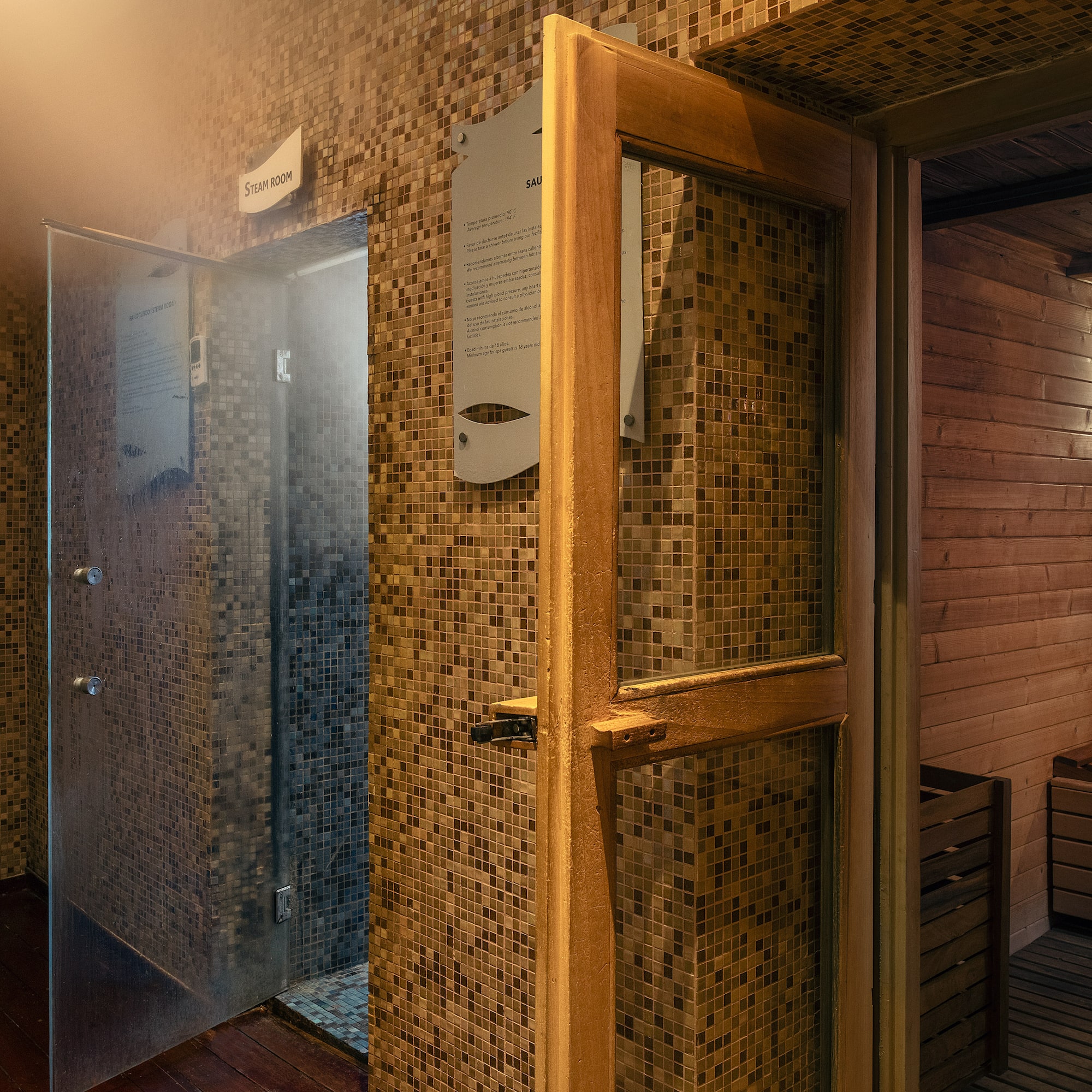 a room with a glass door and a sauna