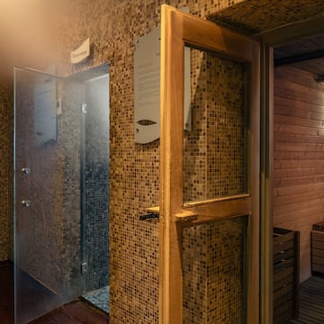 a room with a glass door and a sauna