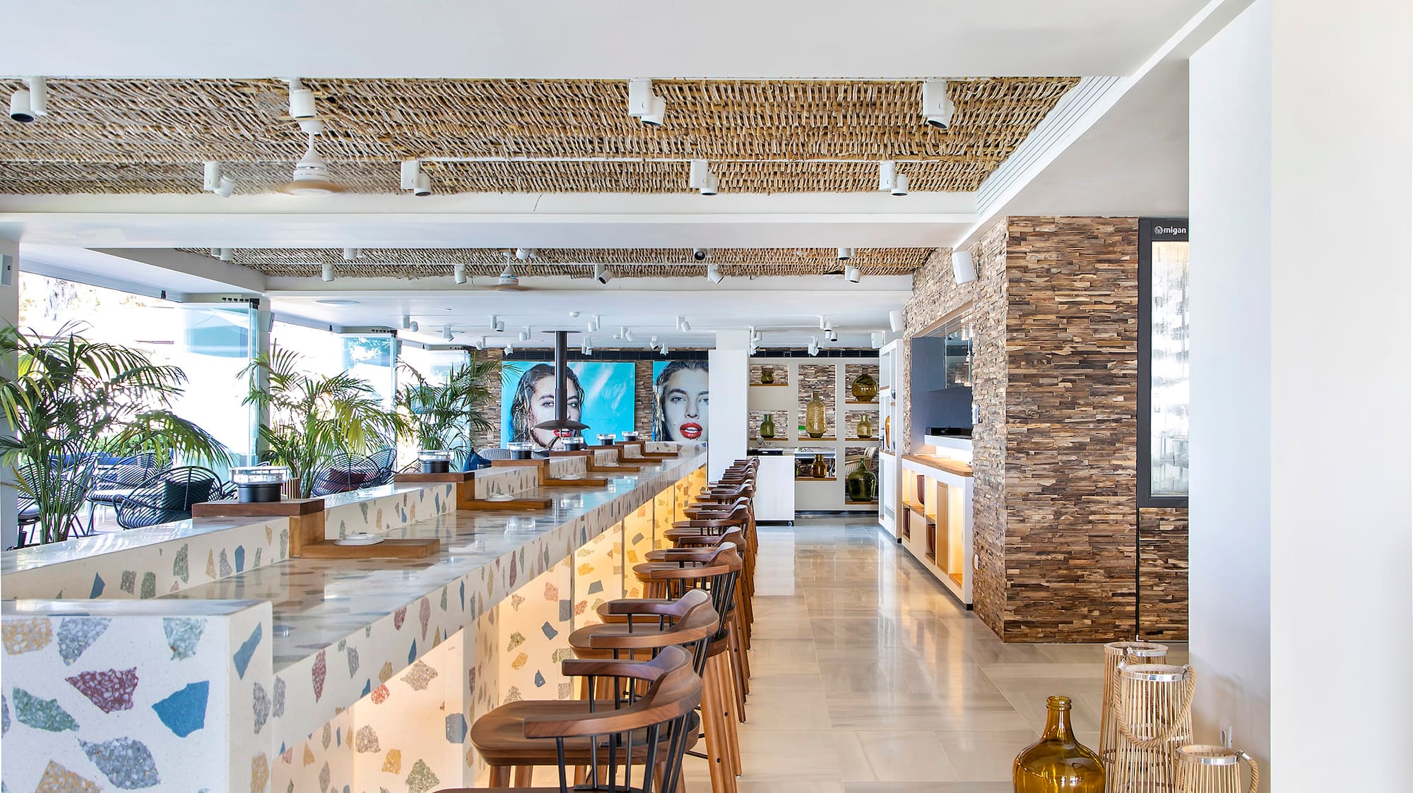 a bar with stools and chairs in a room