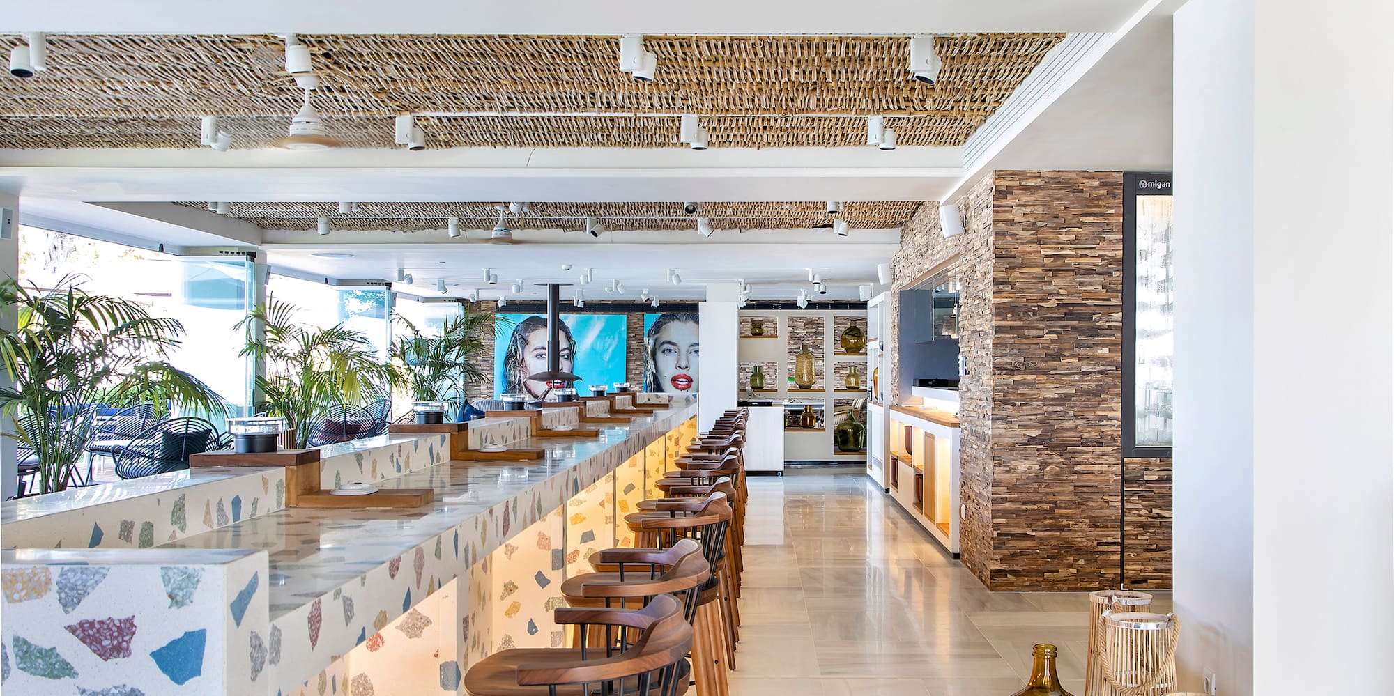 a bar with stools and chairs in a room