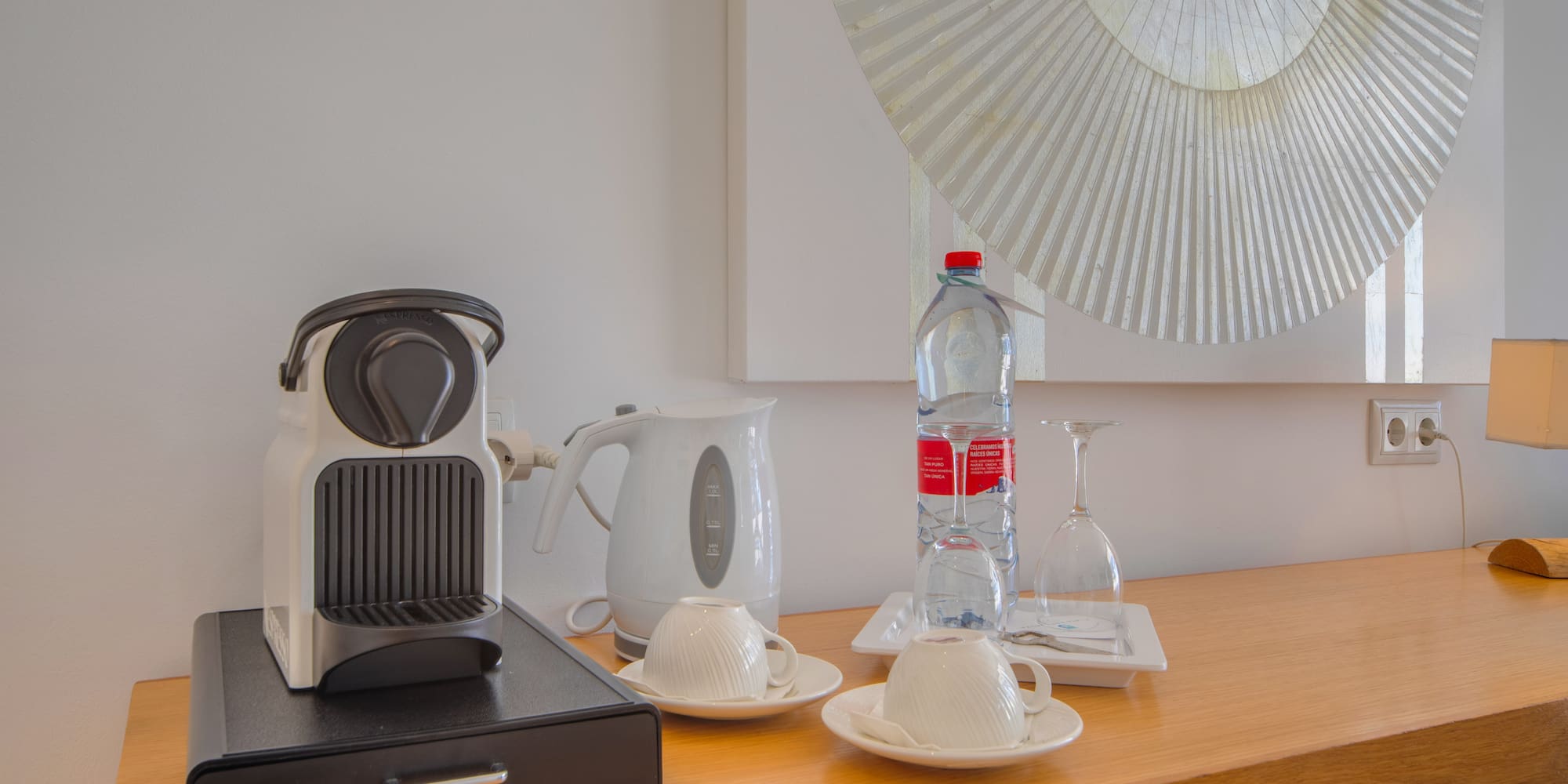 a coffee machine and a bottle of water on a counter