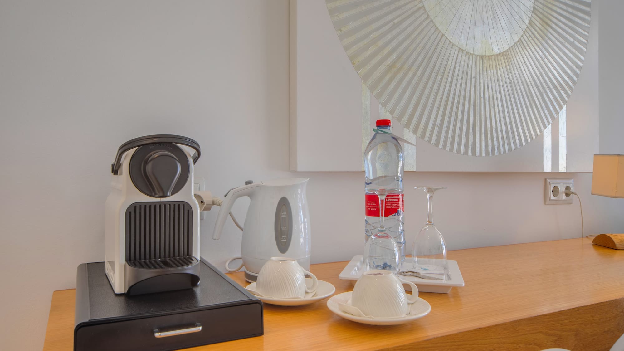 a coffee machine and a bottle of water on a counter