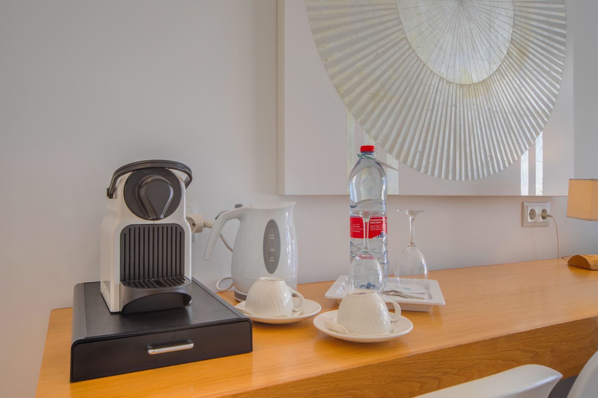 a coffee machine and a bottle of water on a counter