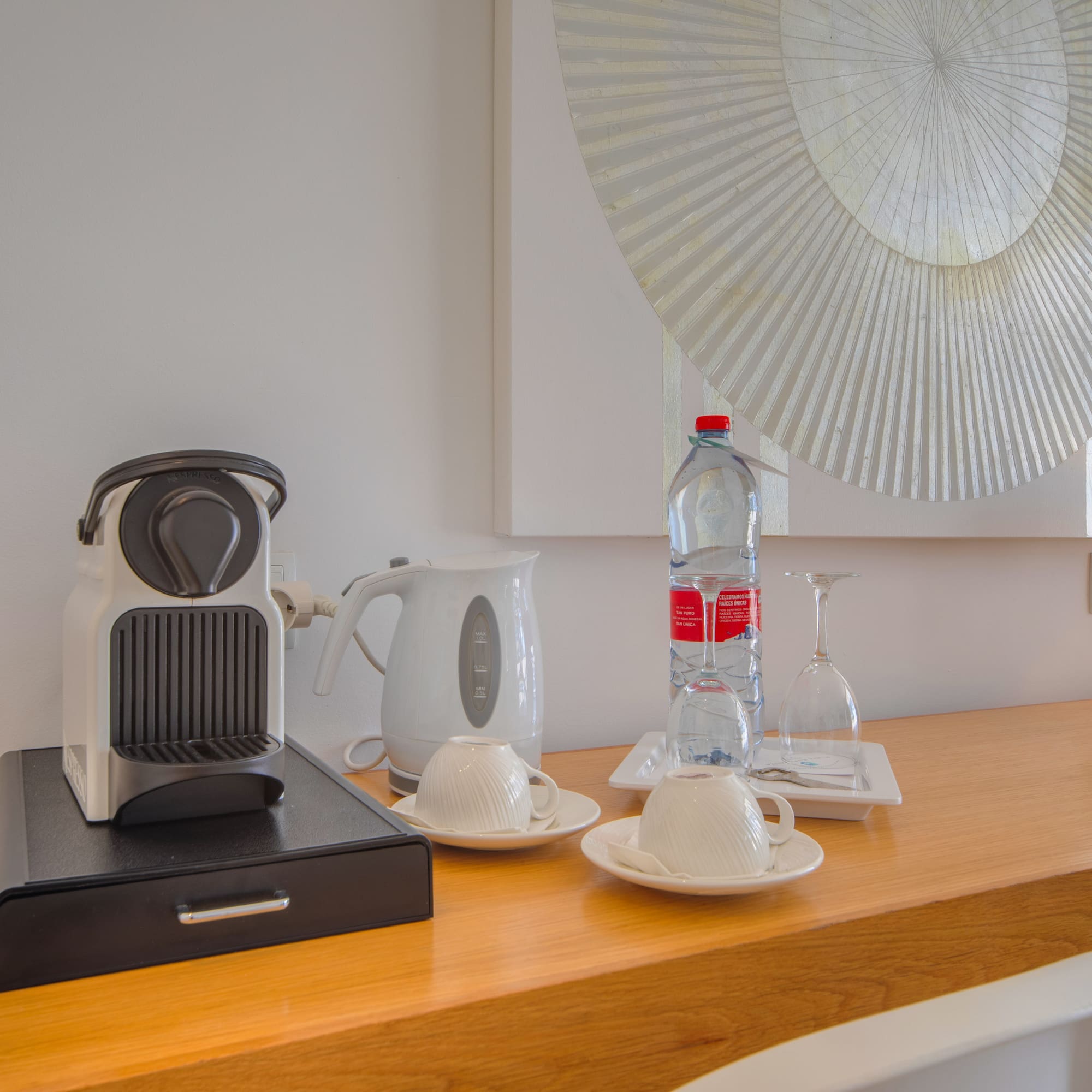 a coffee machine and a bottle of water on a counter