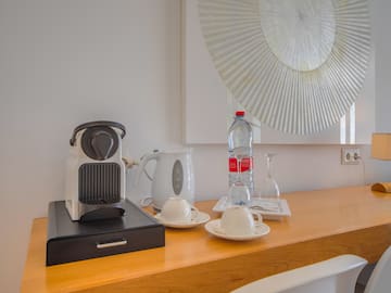 a coffee machine and a bottle of water on a counter