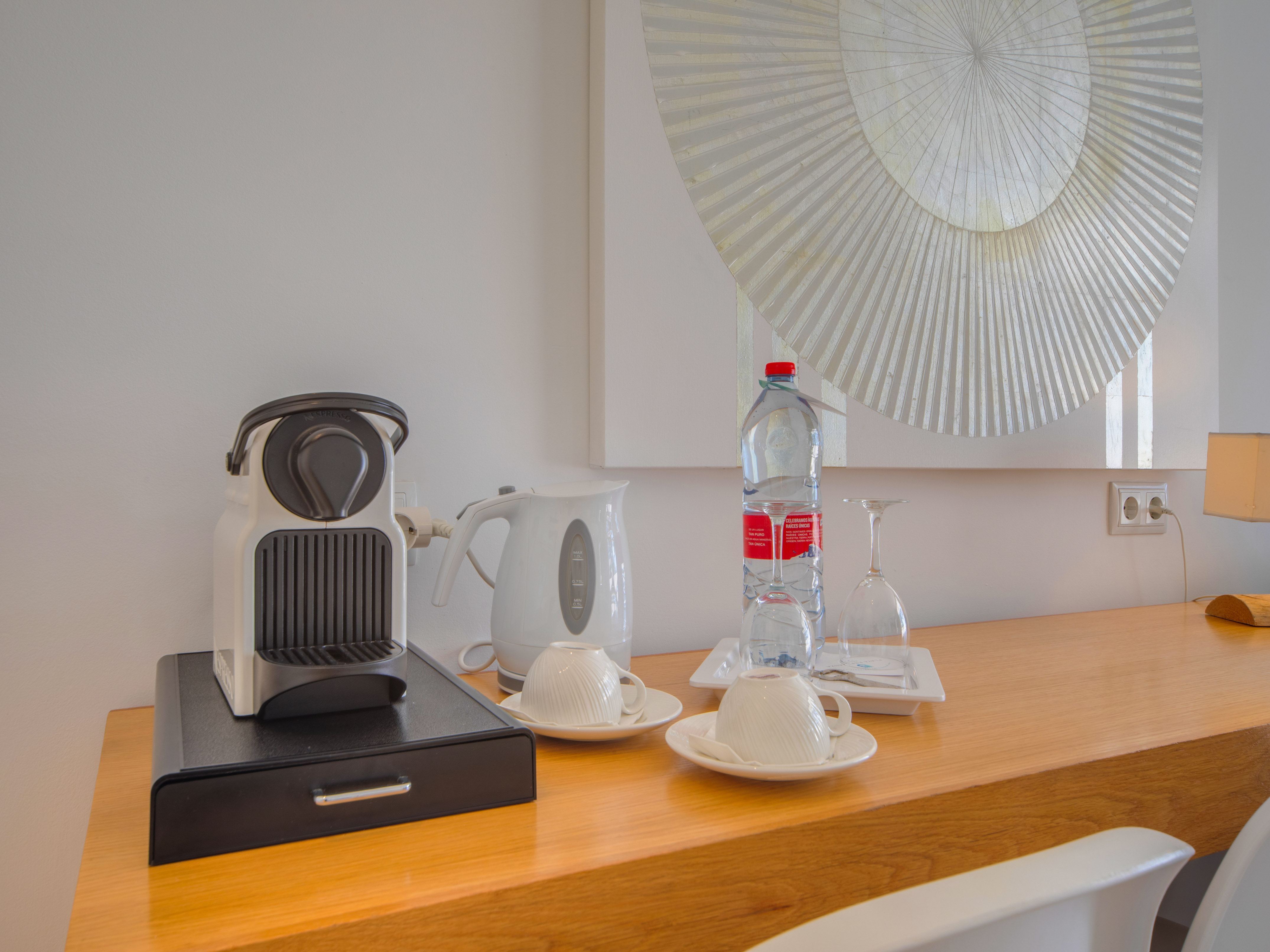 a coffee machine and a bottle of water on a counter