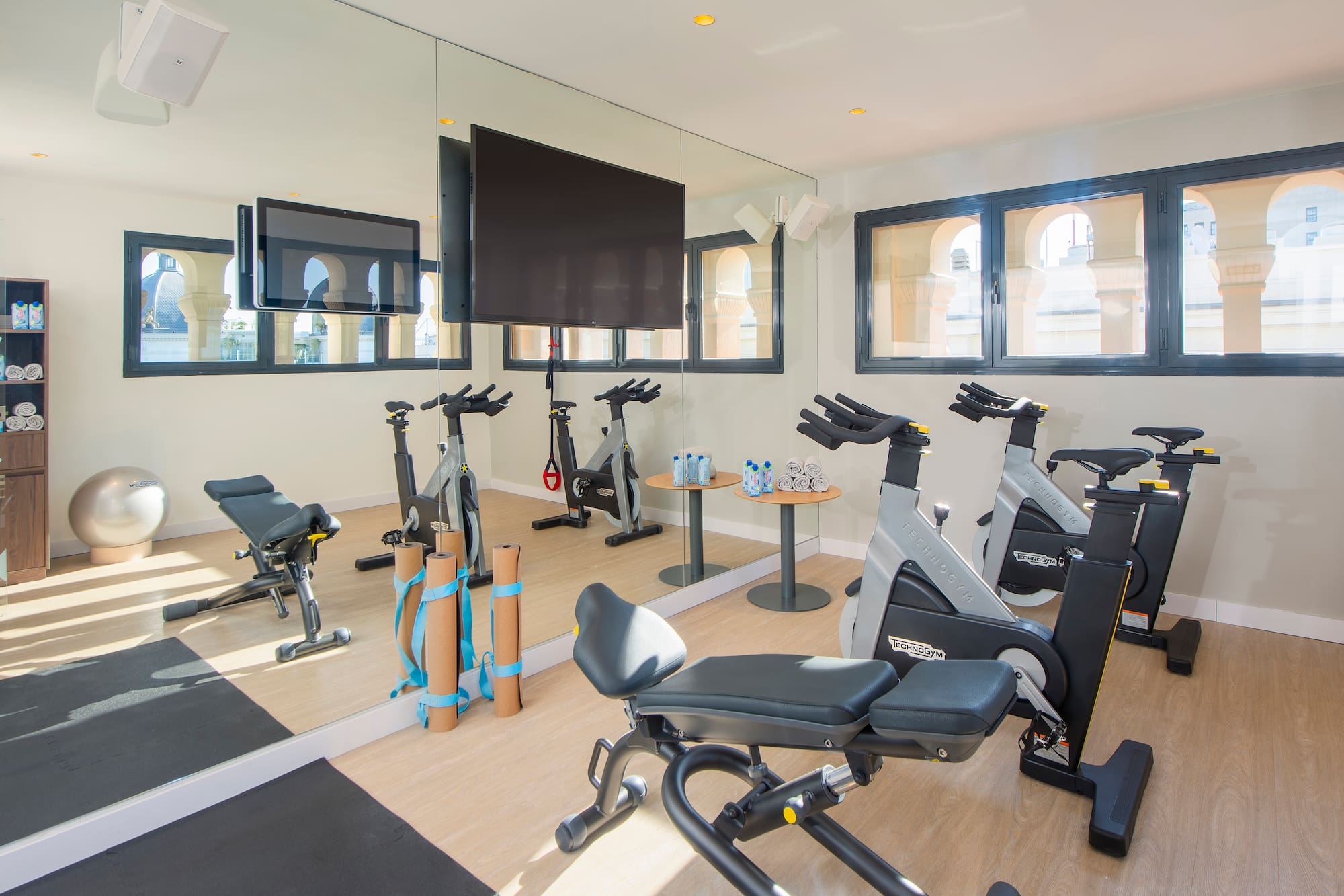 a room with exercise bikes and a mirror