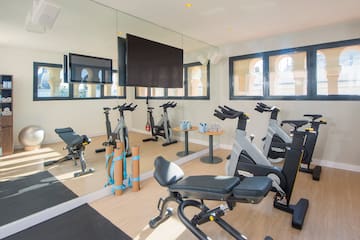 a room with exercise bikes and a mirror