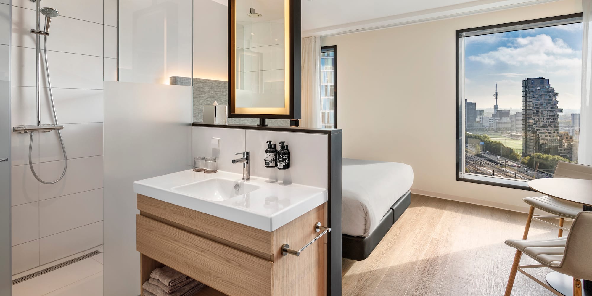 a bathroom with a bed and a mirror