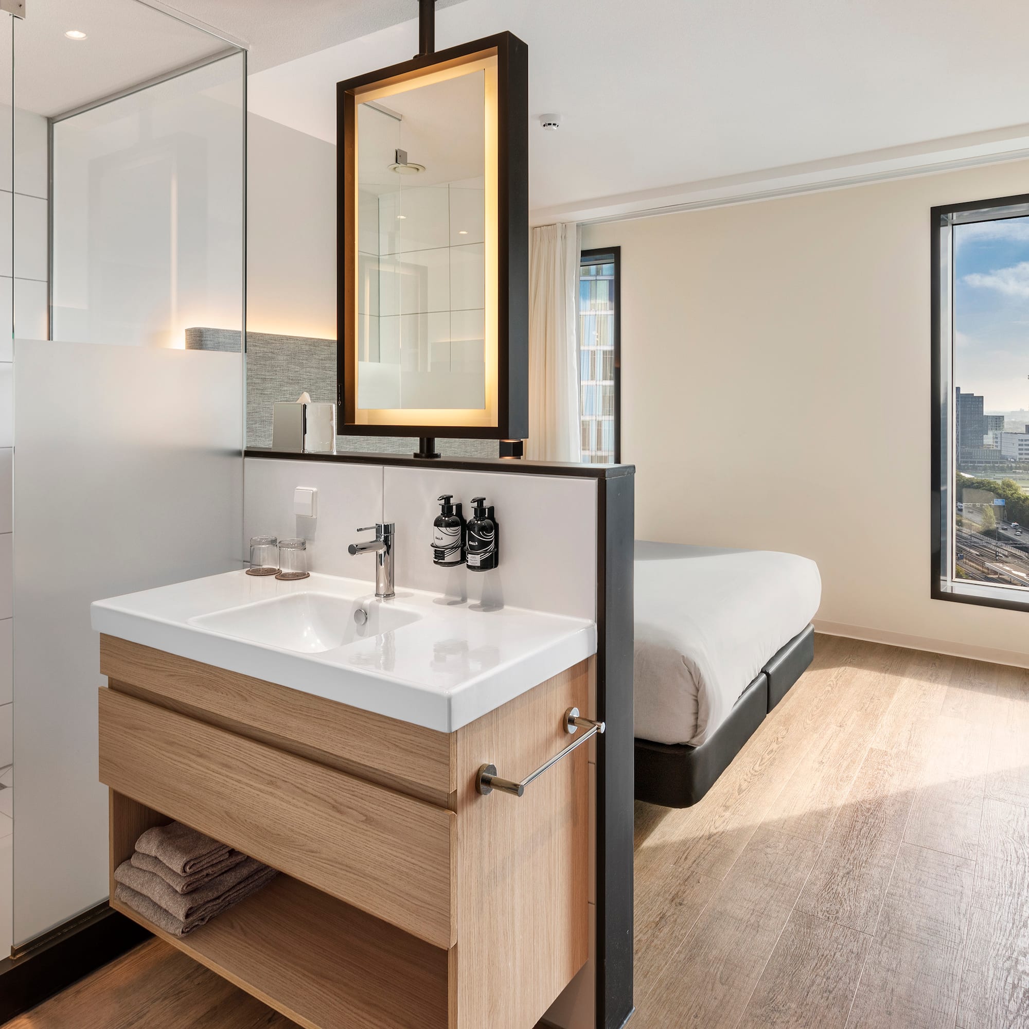 a bathroom with a bed and a mirror