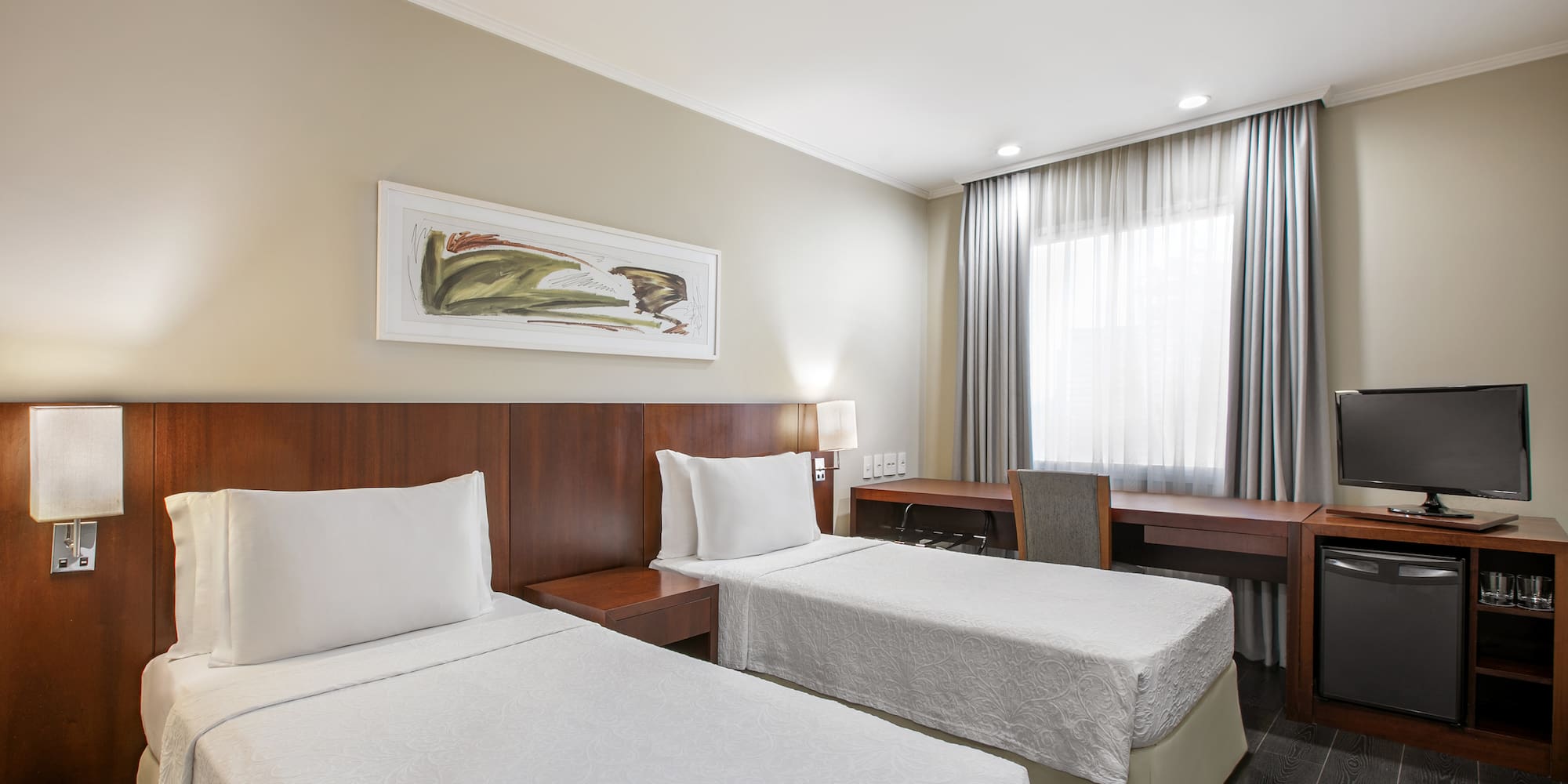 a room with two beds and a desk