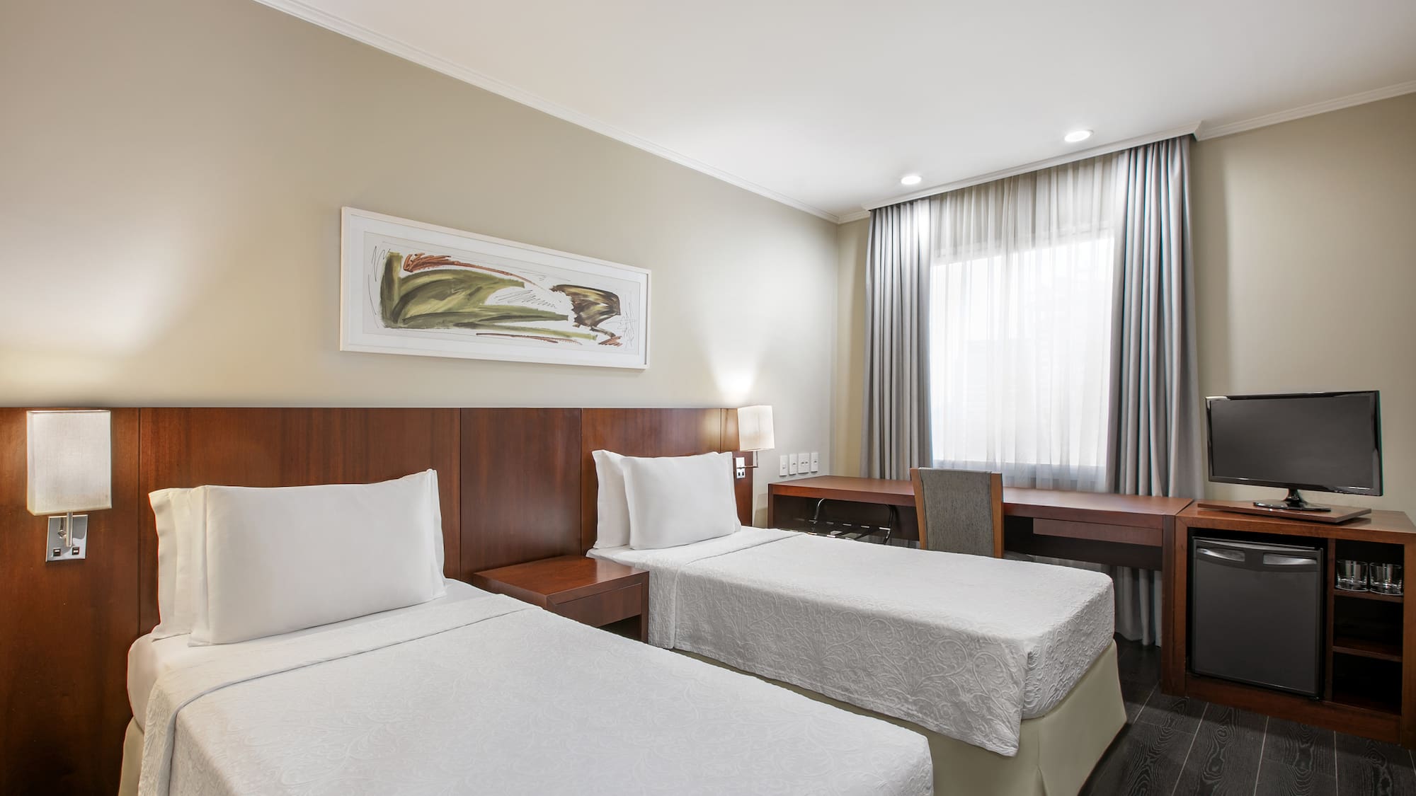 a room with two beds and a desk