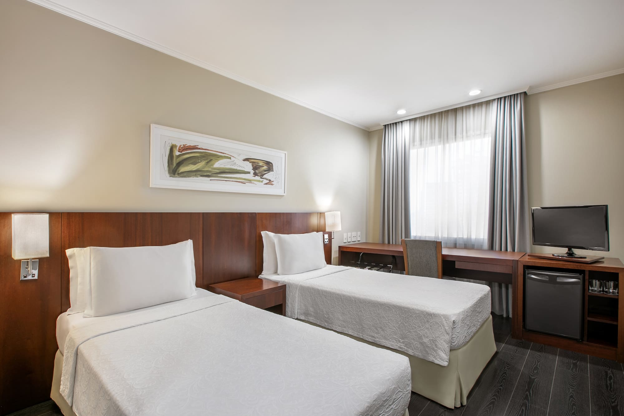 a room with two beds and a desk