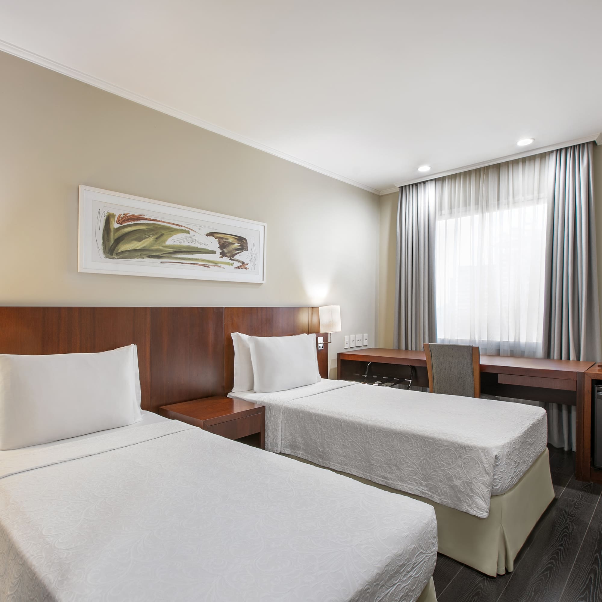 a room with two beds and a desk