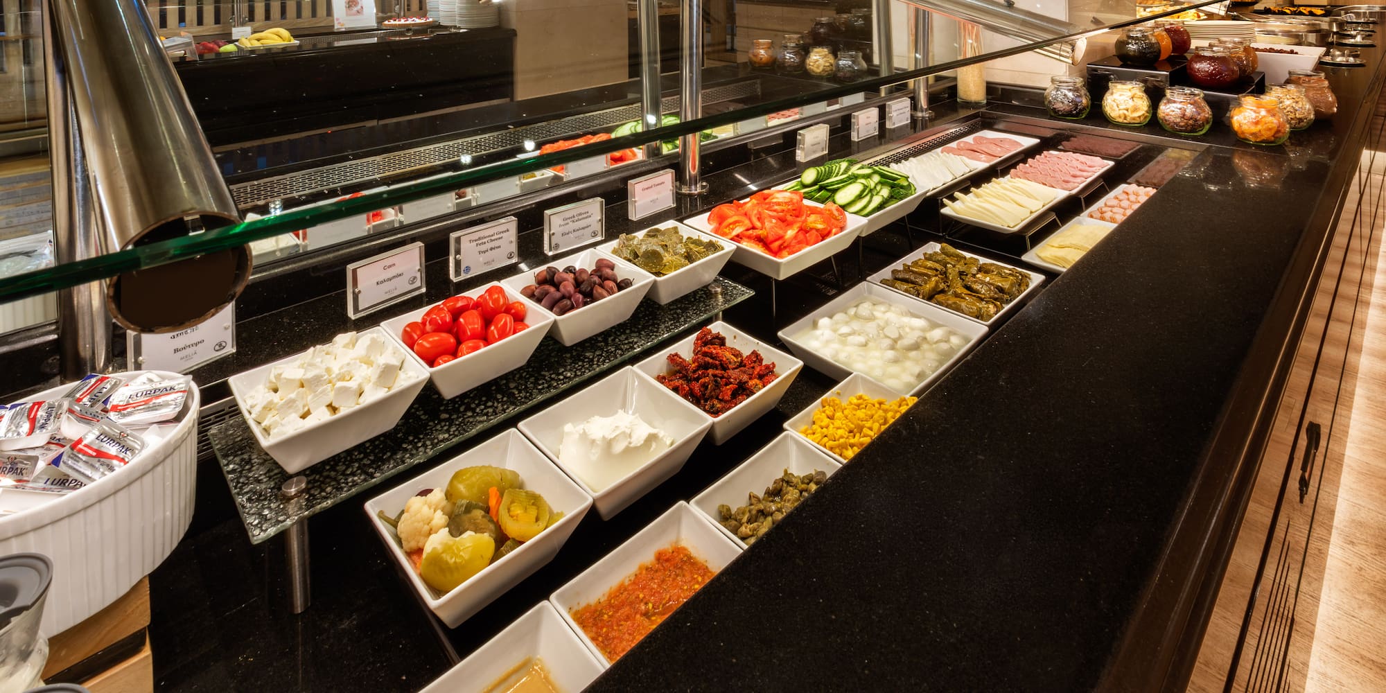 Hotel buffet: fresh vegetables, cheeses, meats, olives, and various dips.