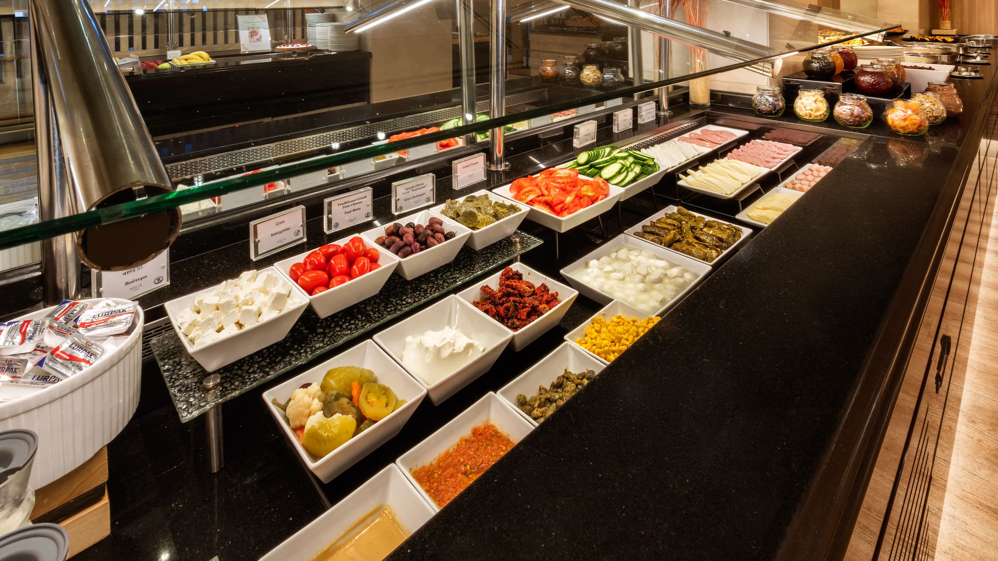 Hotel buffet: fresh vegetables, cheeses, meats, olives, and various dips.