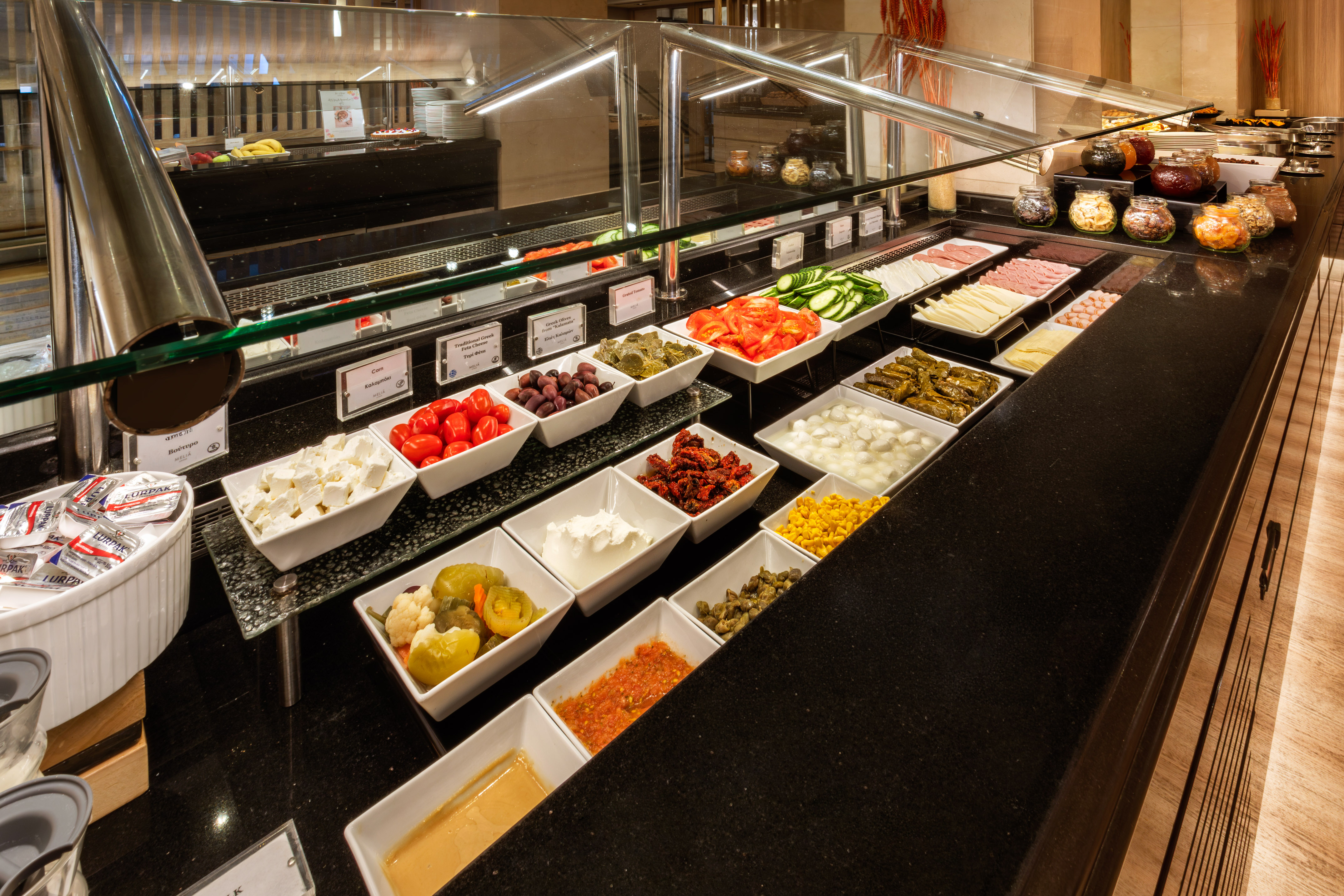 Hotel buffet: fresh vegetables, cheeses, meats, olives, and various dips.