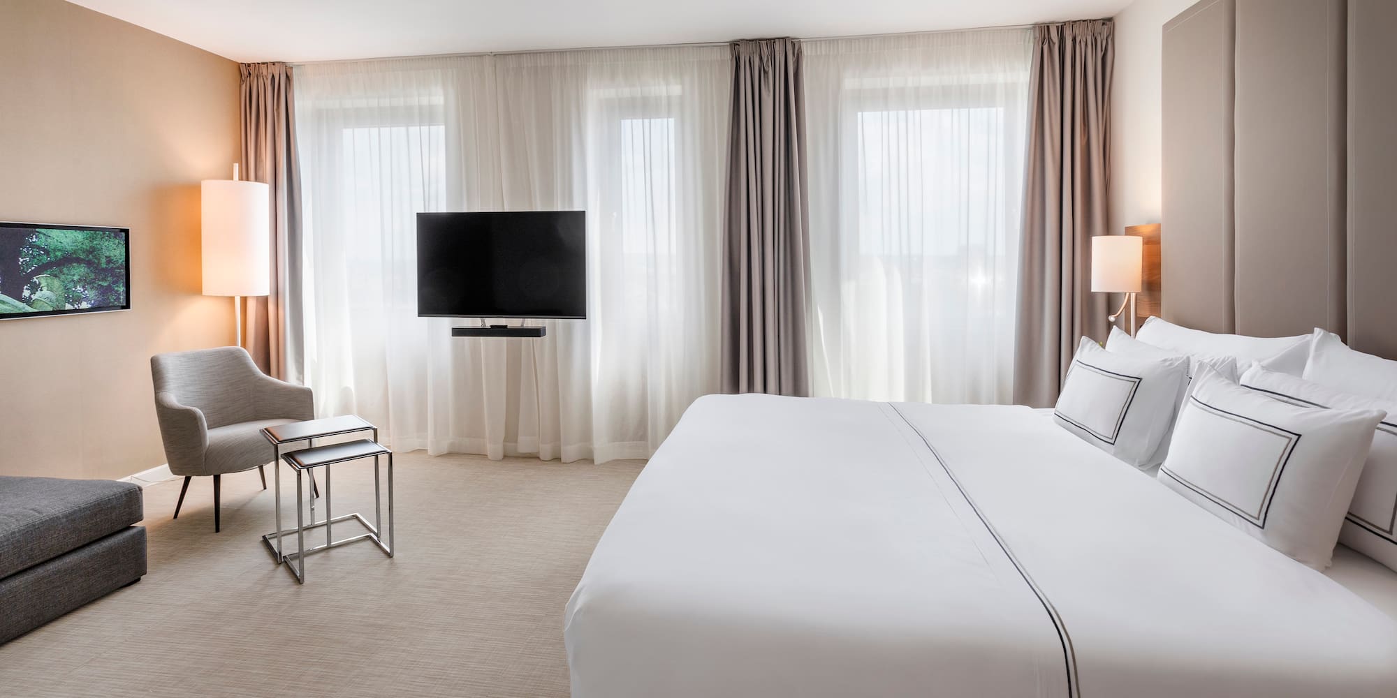 a hotel room with a bed and a television