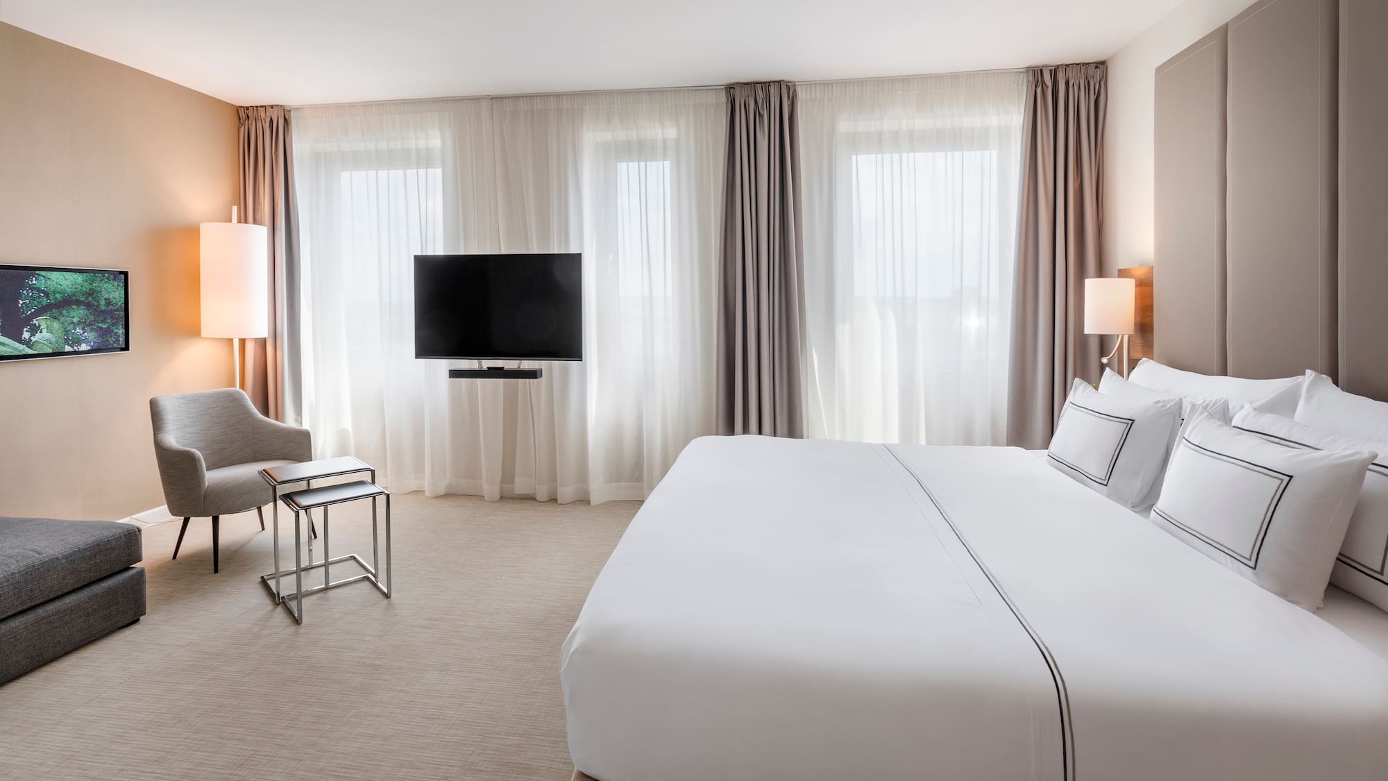 a hotel room with a bed and a television