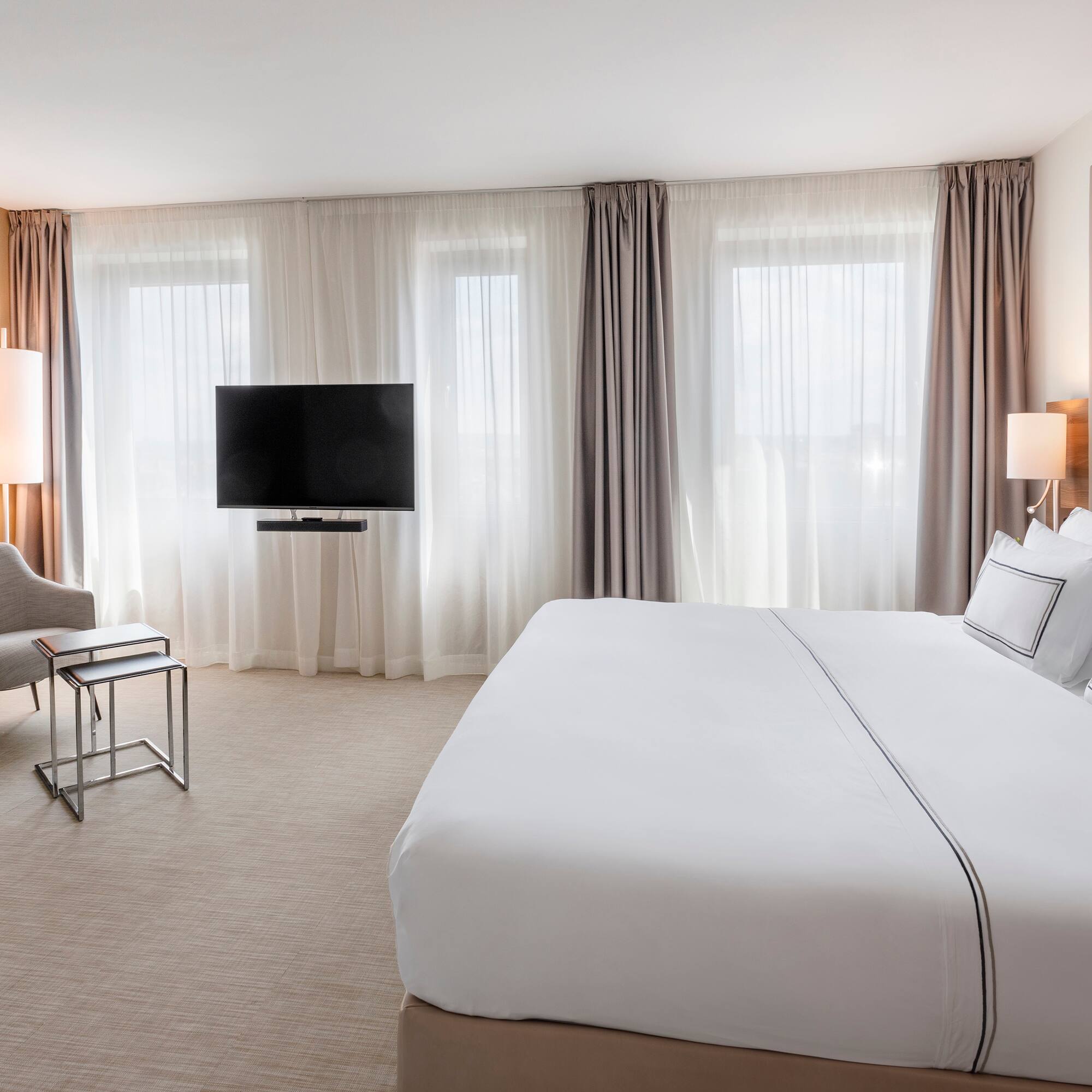 a hotel room with a bed and a television