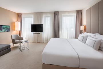 a hotel room with a bed and a television