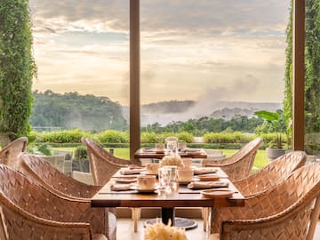 a table with chairs and plates on it