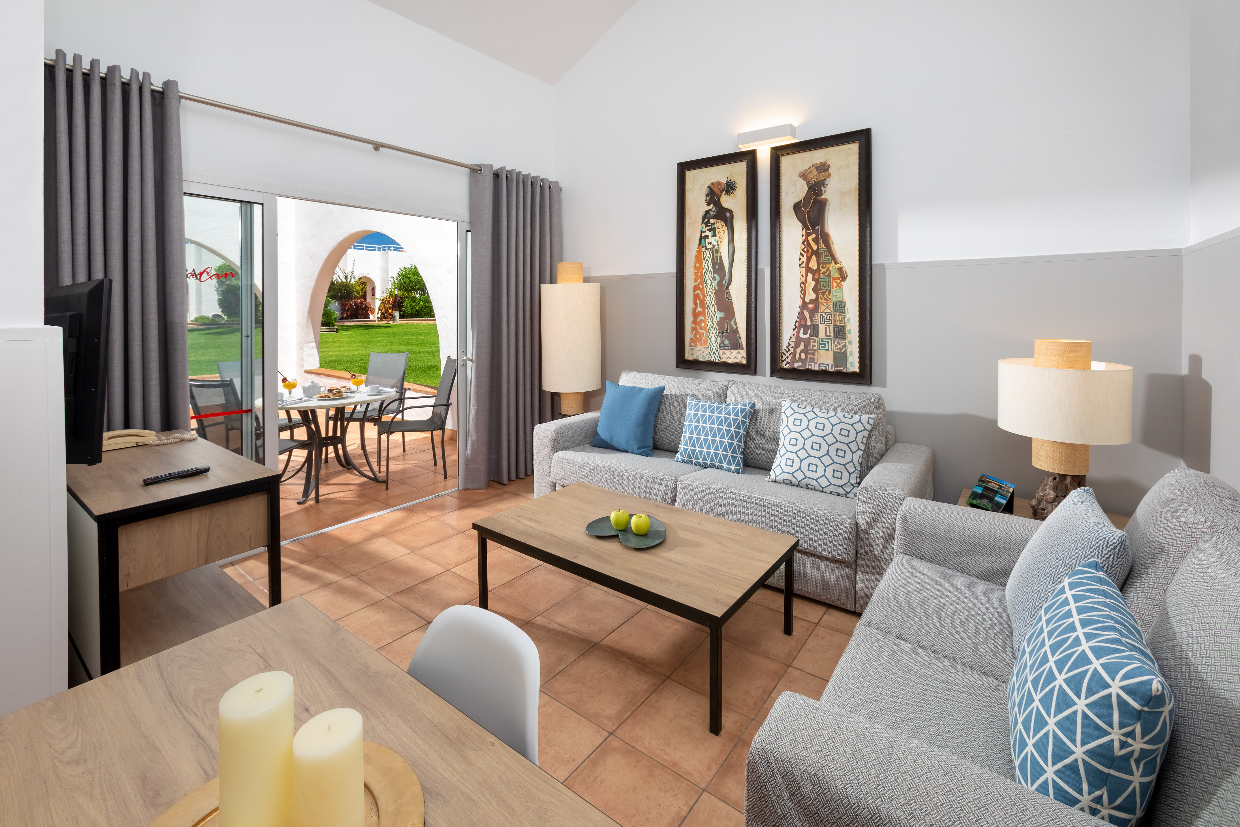 Modern resort apartment living room with patio, sofas, and contemporary decor.