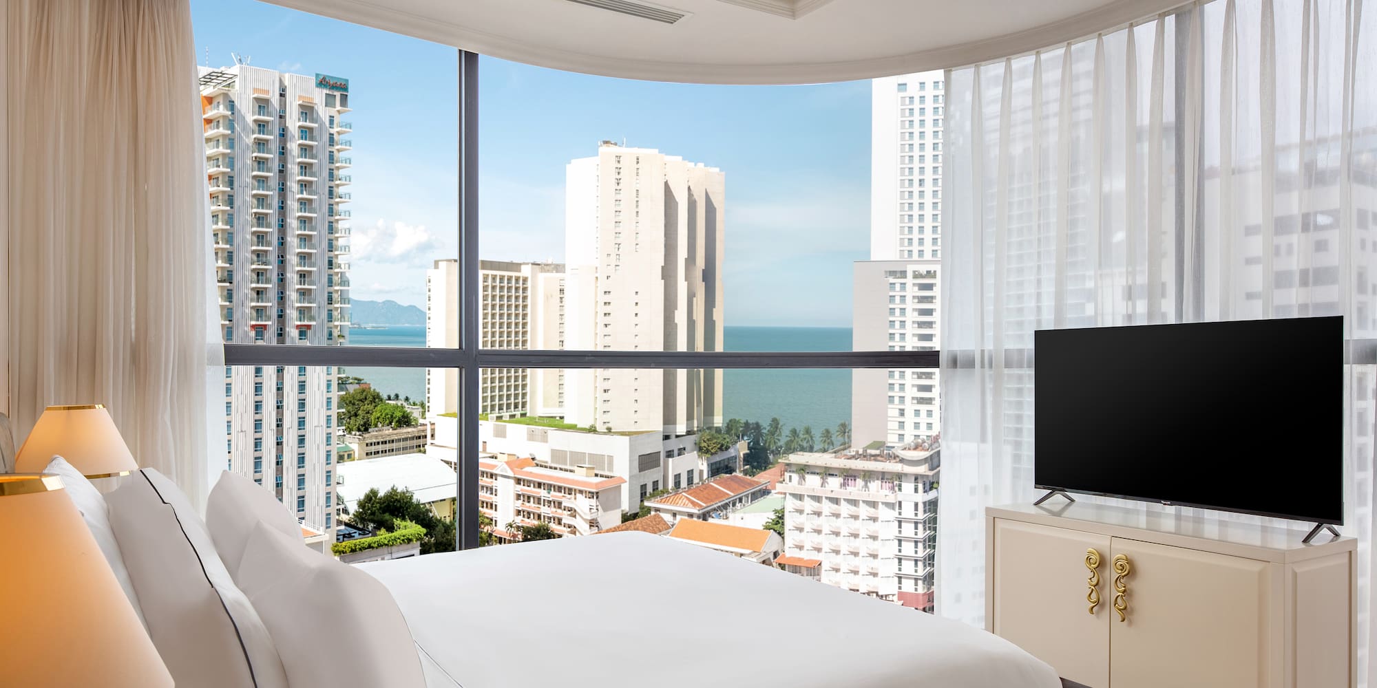 a bedroom with a television and a city view