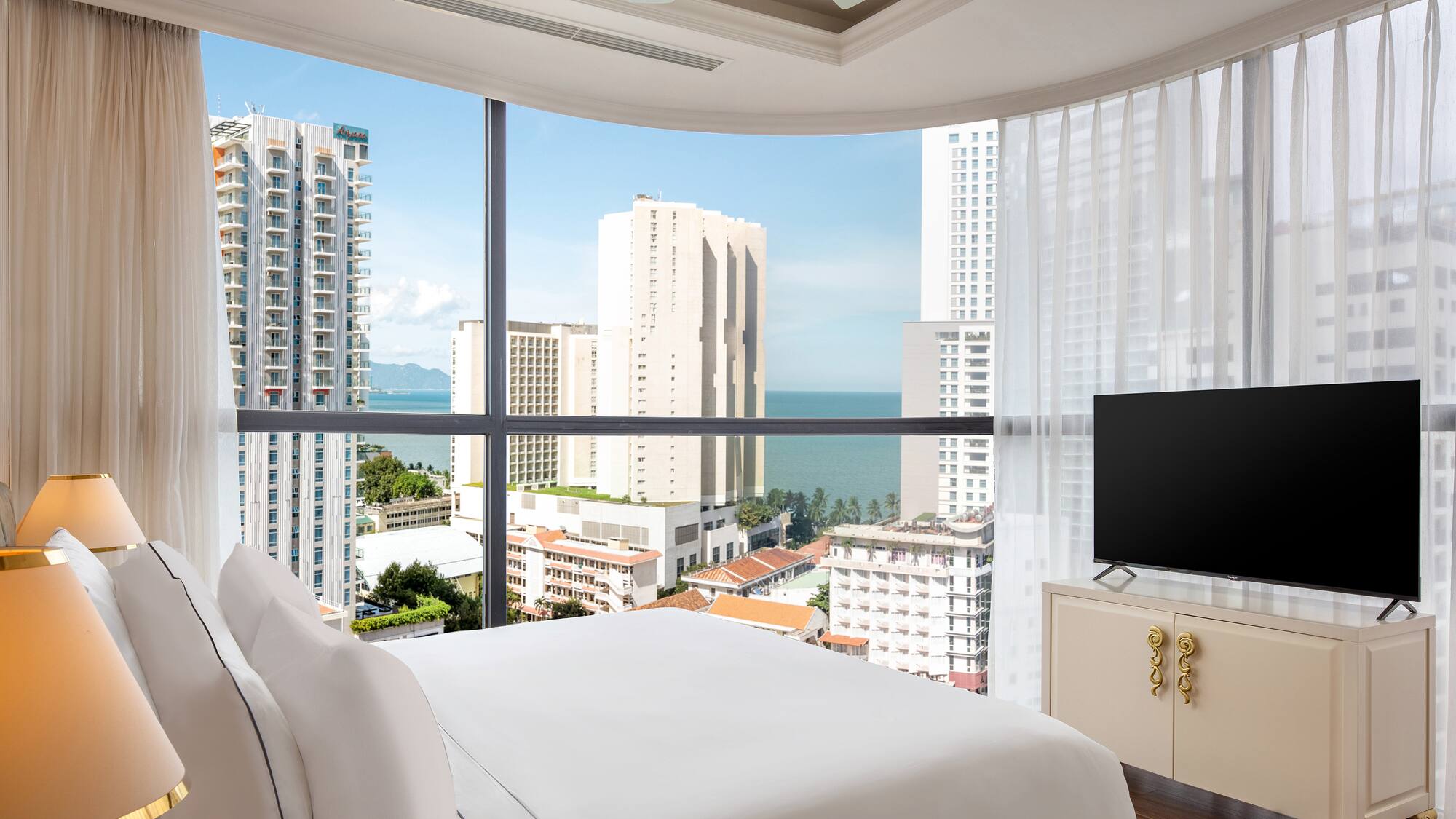 a bedroom with a television and a city view