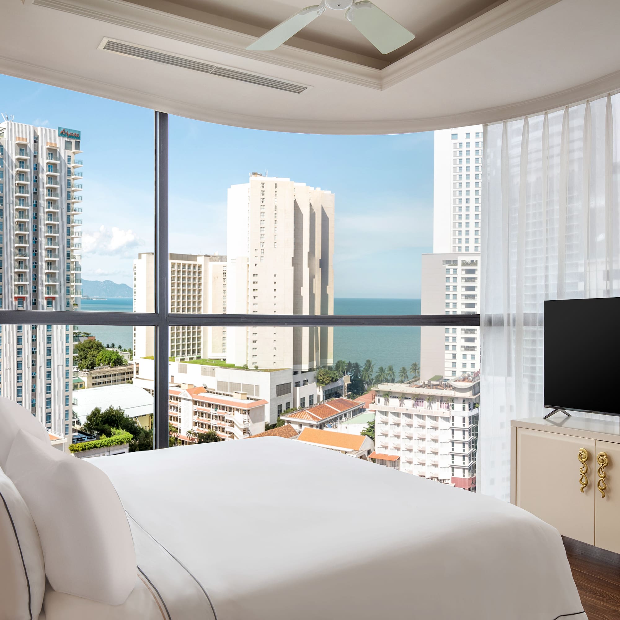 a bedroom with a television and a city view