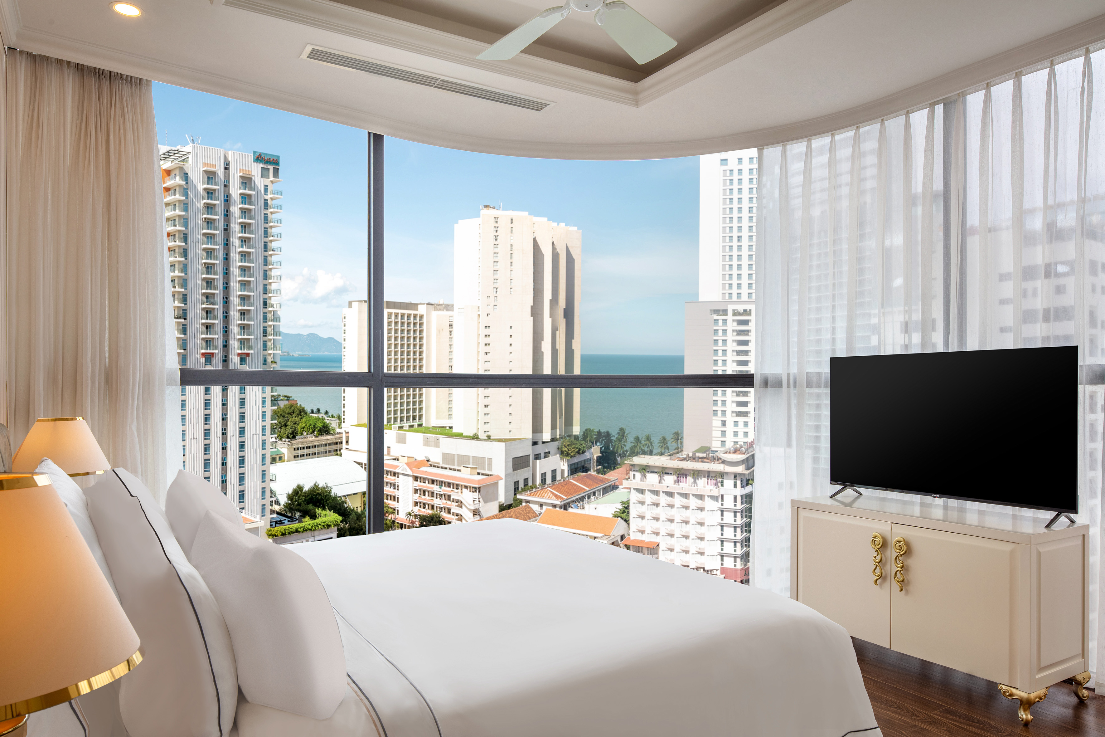 a bedroom with a television and a city view