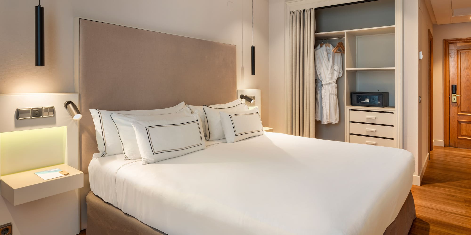 a bed with a white bedding and a closet