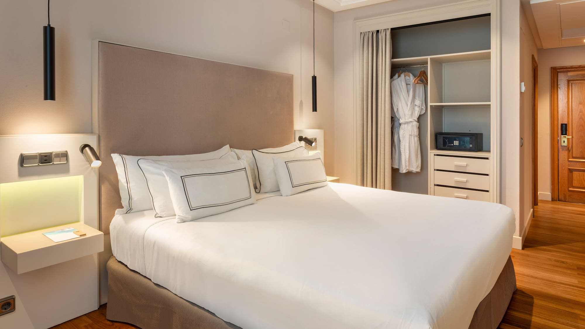 a bed with a white bedding and a closet