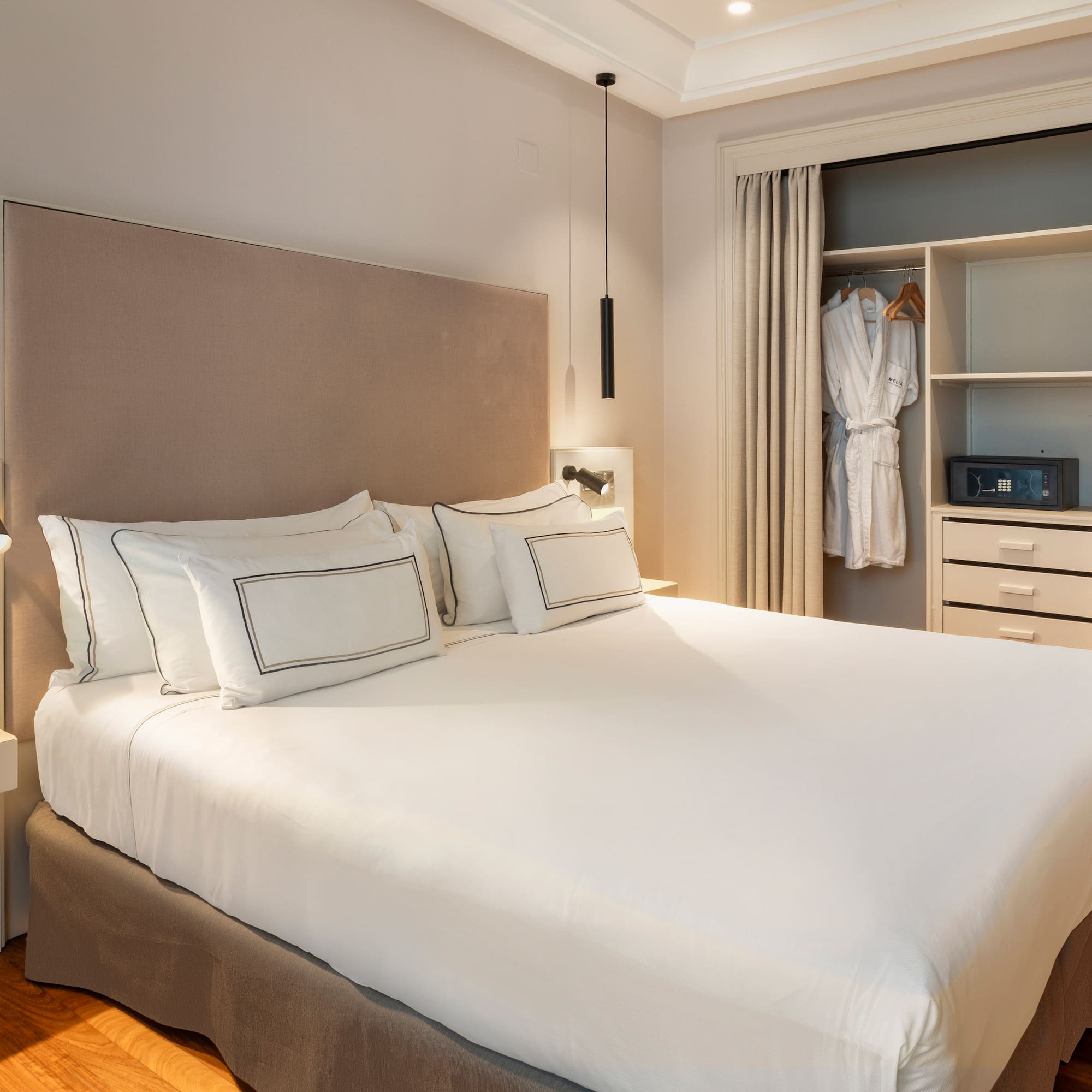 a bed with a white bedding and a closet