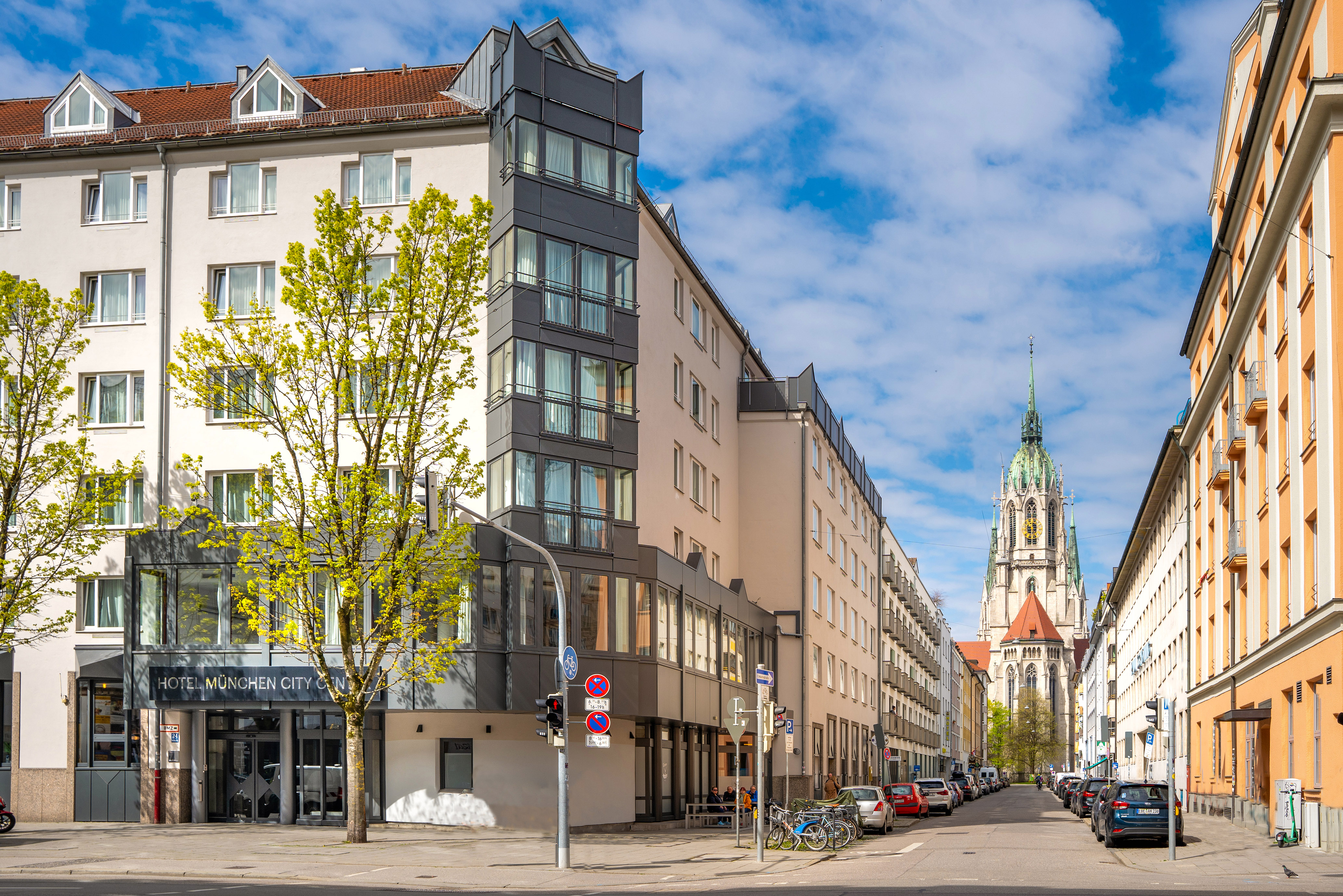 Hotel München City Center, Munich street with St. Paul's Church spire.