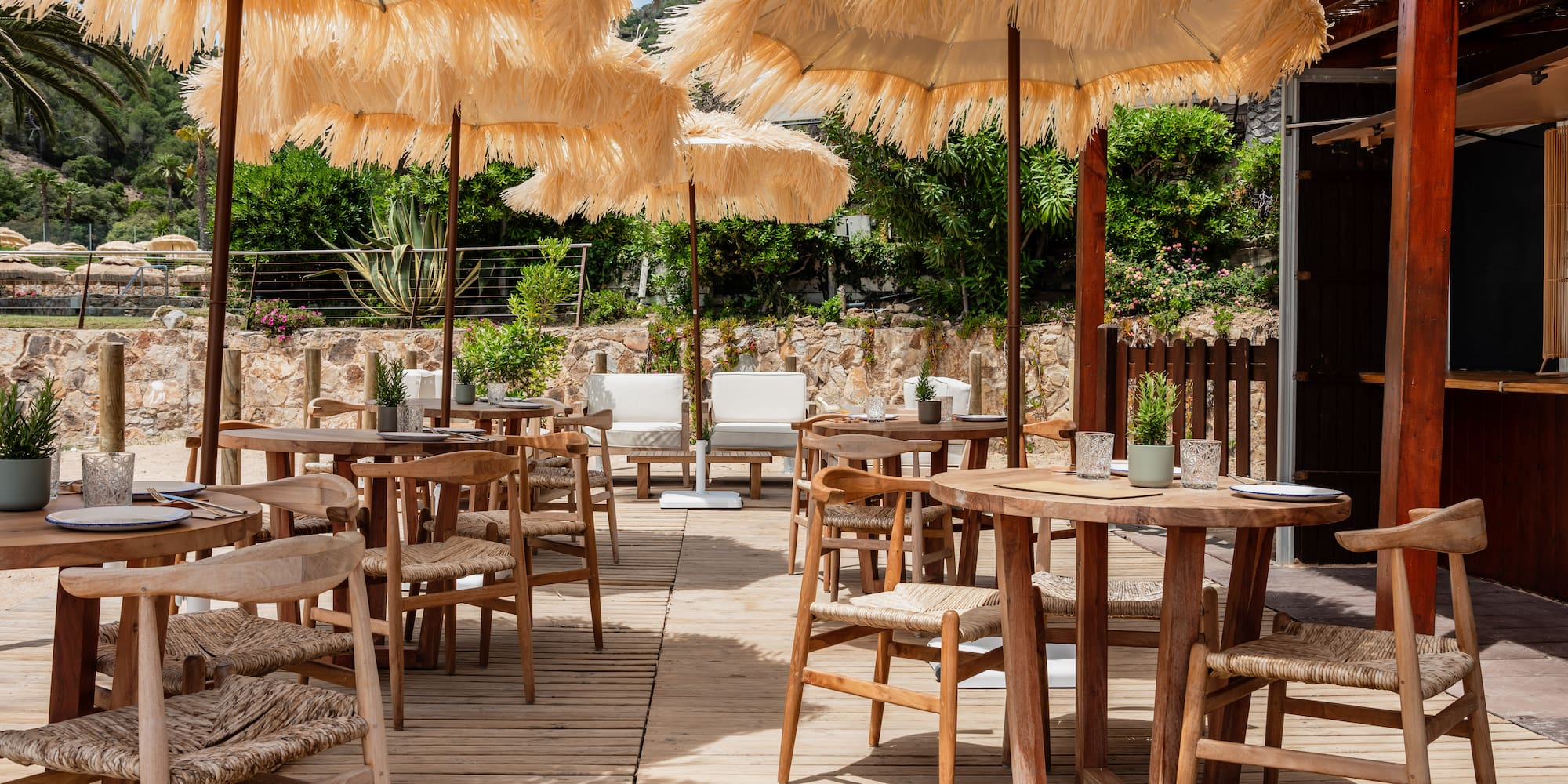 a patio with tables and chairs and umbrellas