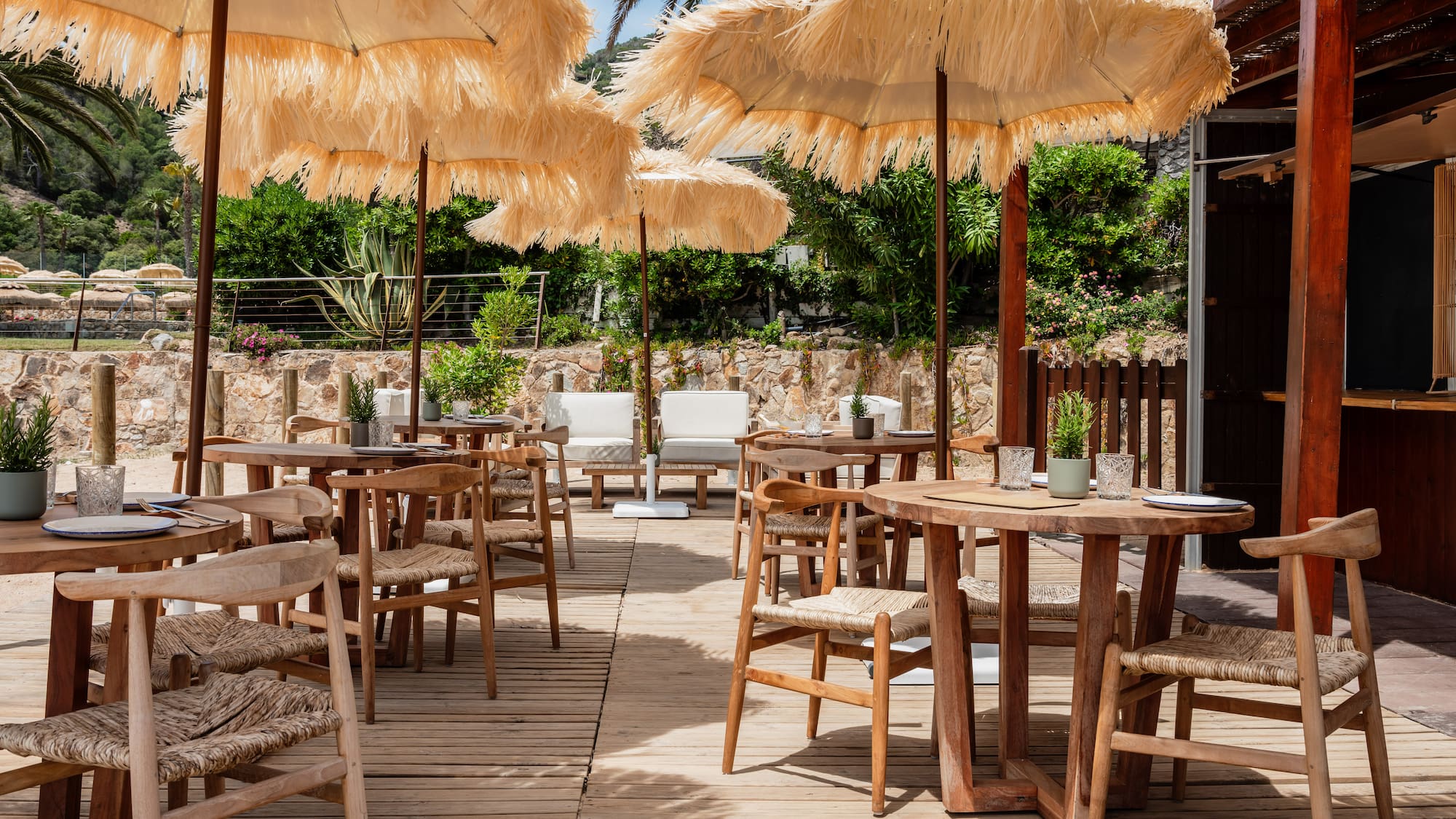 a patio with tables and chairs and umbrellas