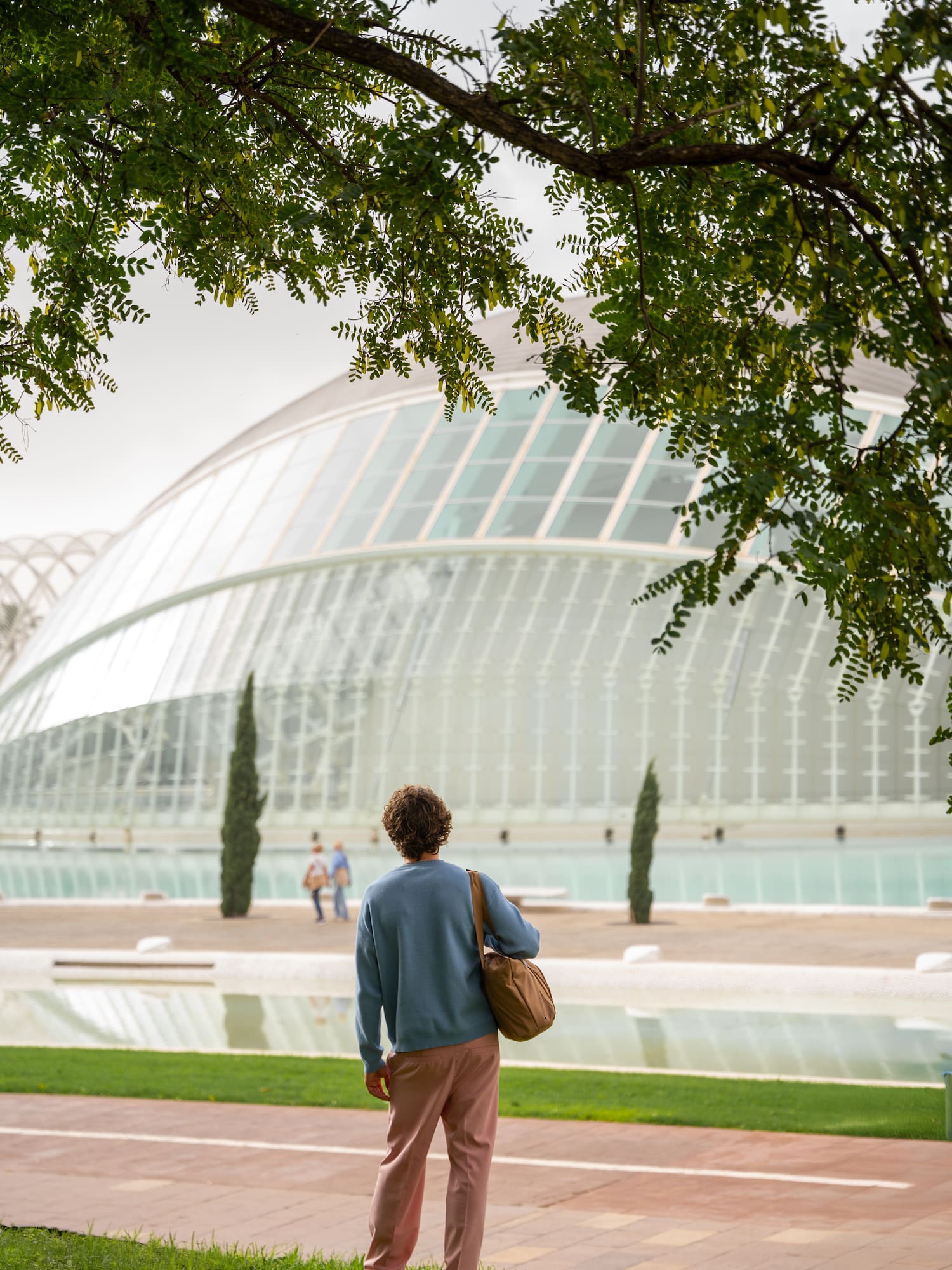 a person standing in front of a glass building