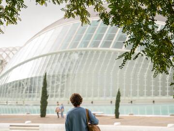 a person standing in front of a glass building