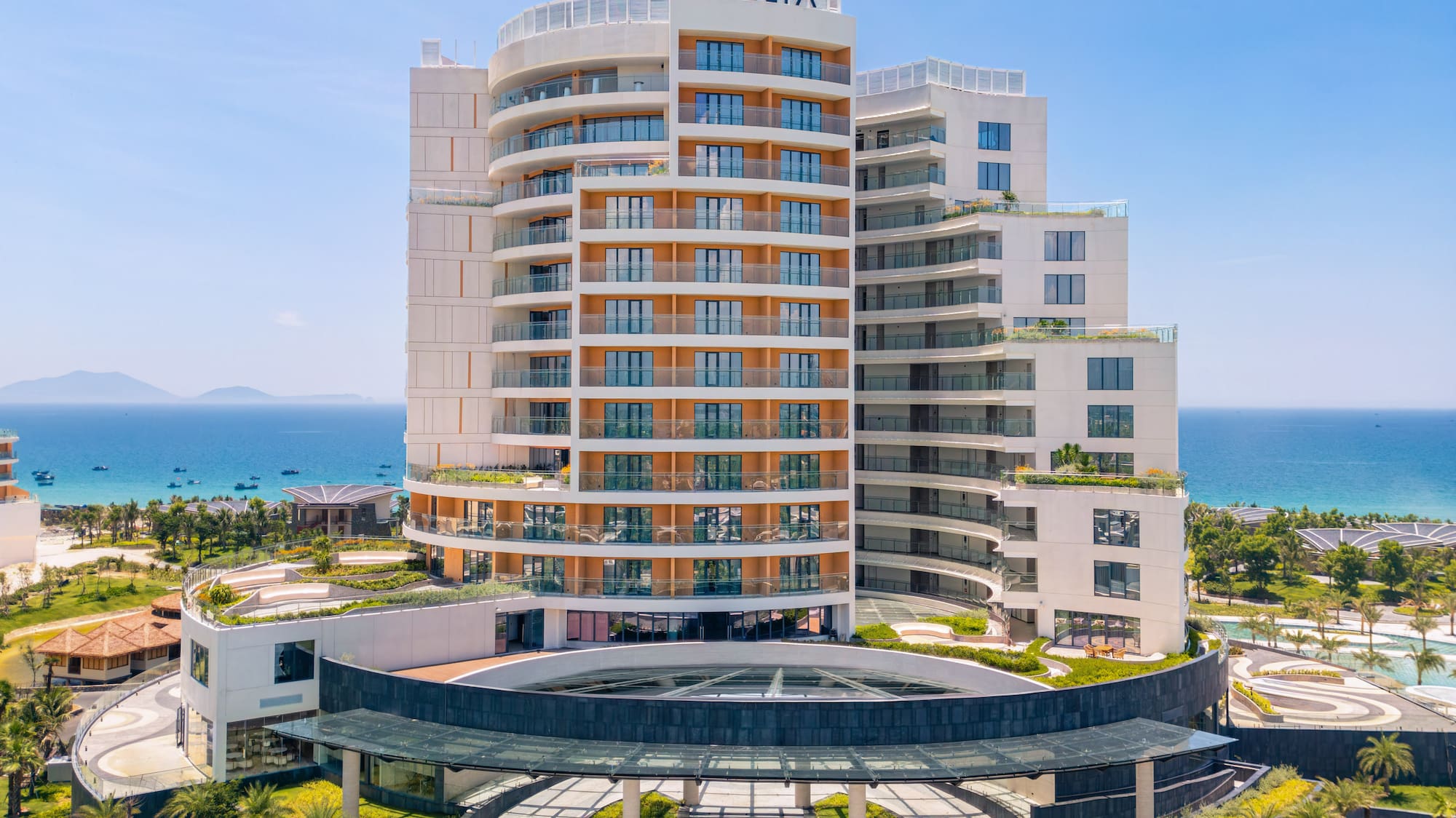 Melia oceanfront resort, modern building, grand entrance, lush palm trees.