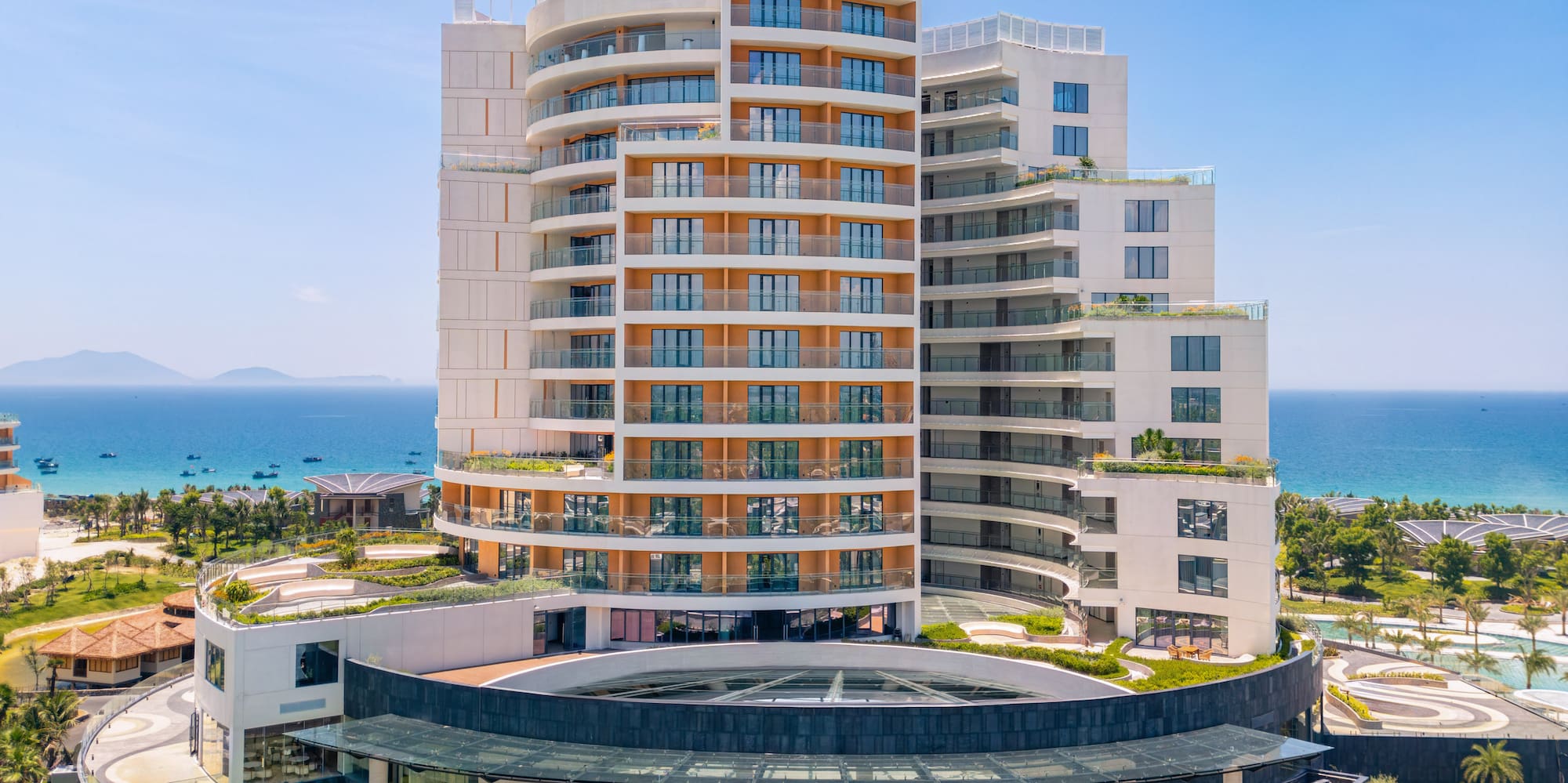 Melia oceanfront resort, modern building, grand entrance, lush palm trees.