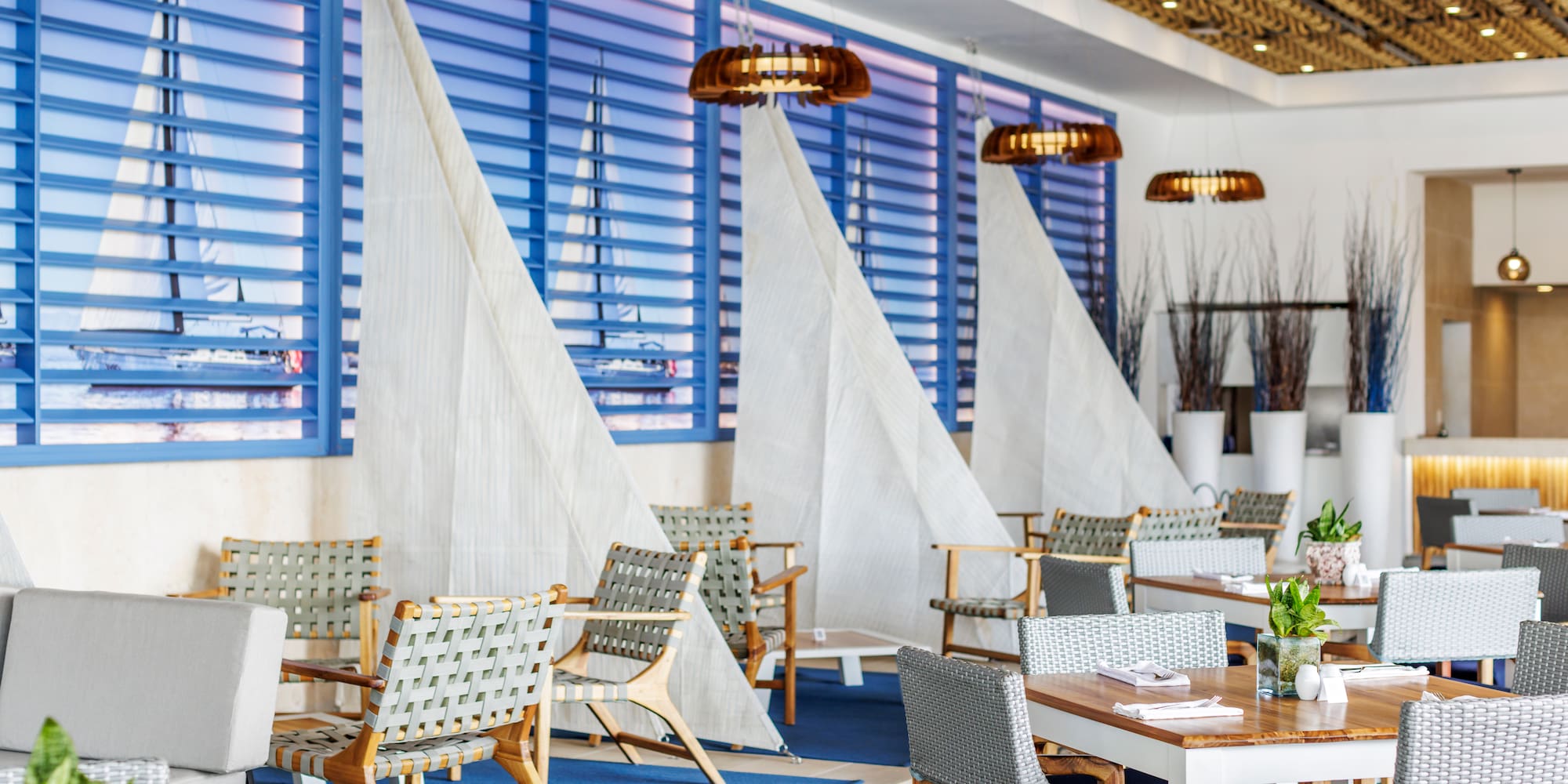 a room with tables and chairs and sailboats