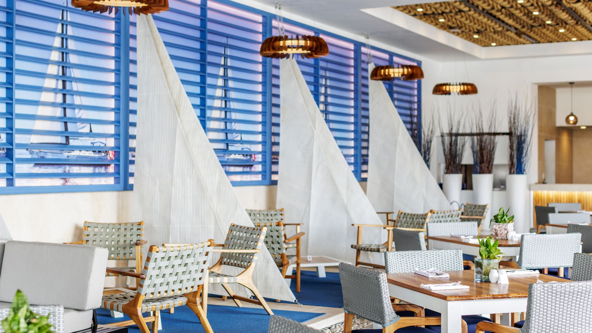 a room with tables and chairs and sailboats