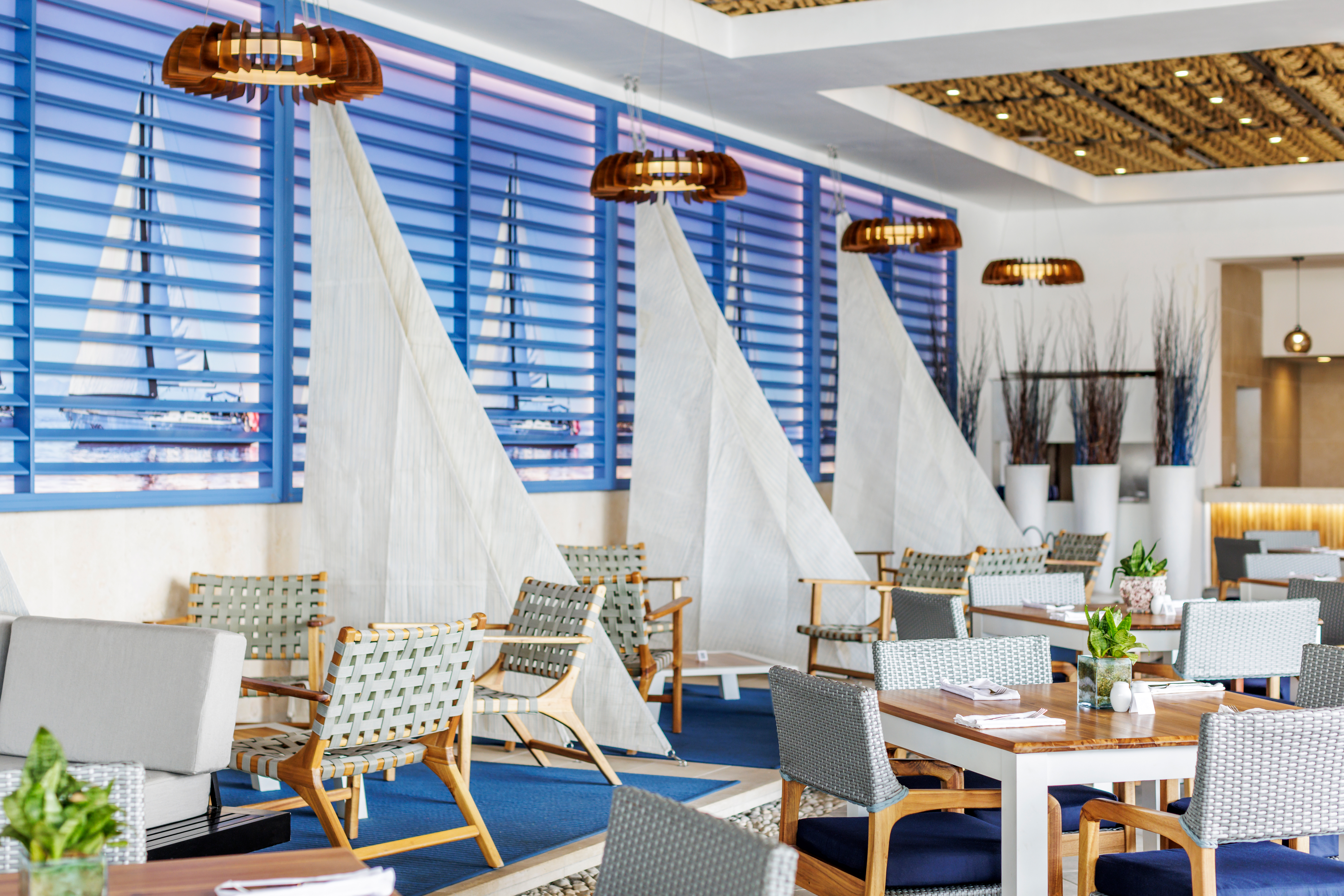 a room with tables and chairs and sailboats