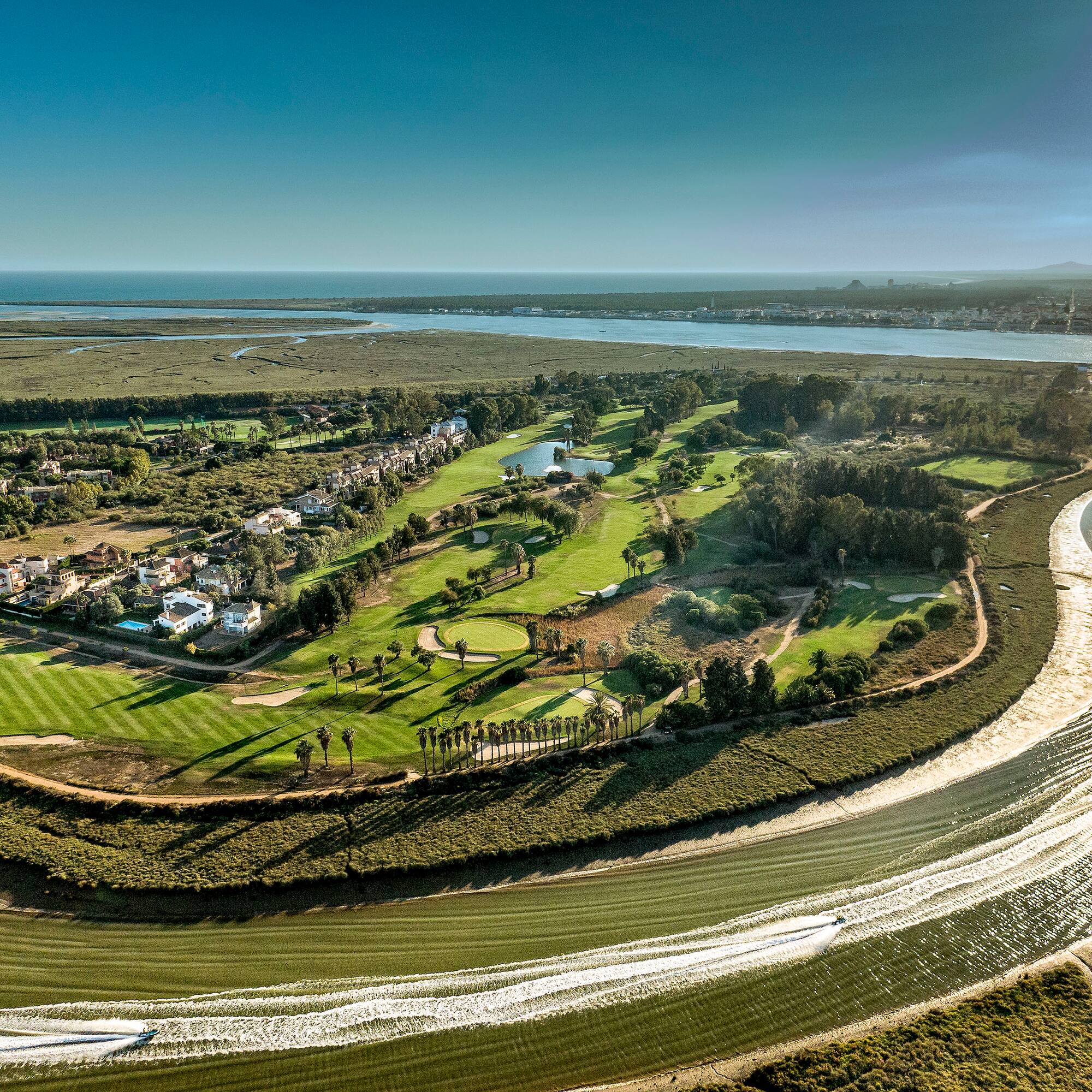 a landscape with a river and a green field